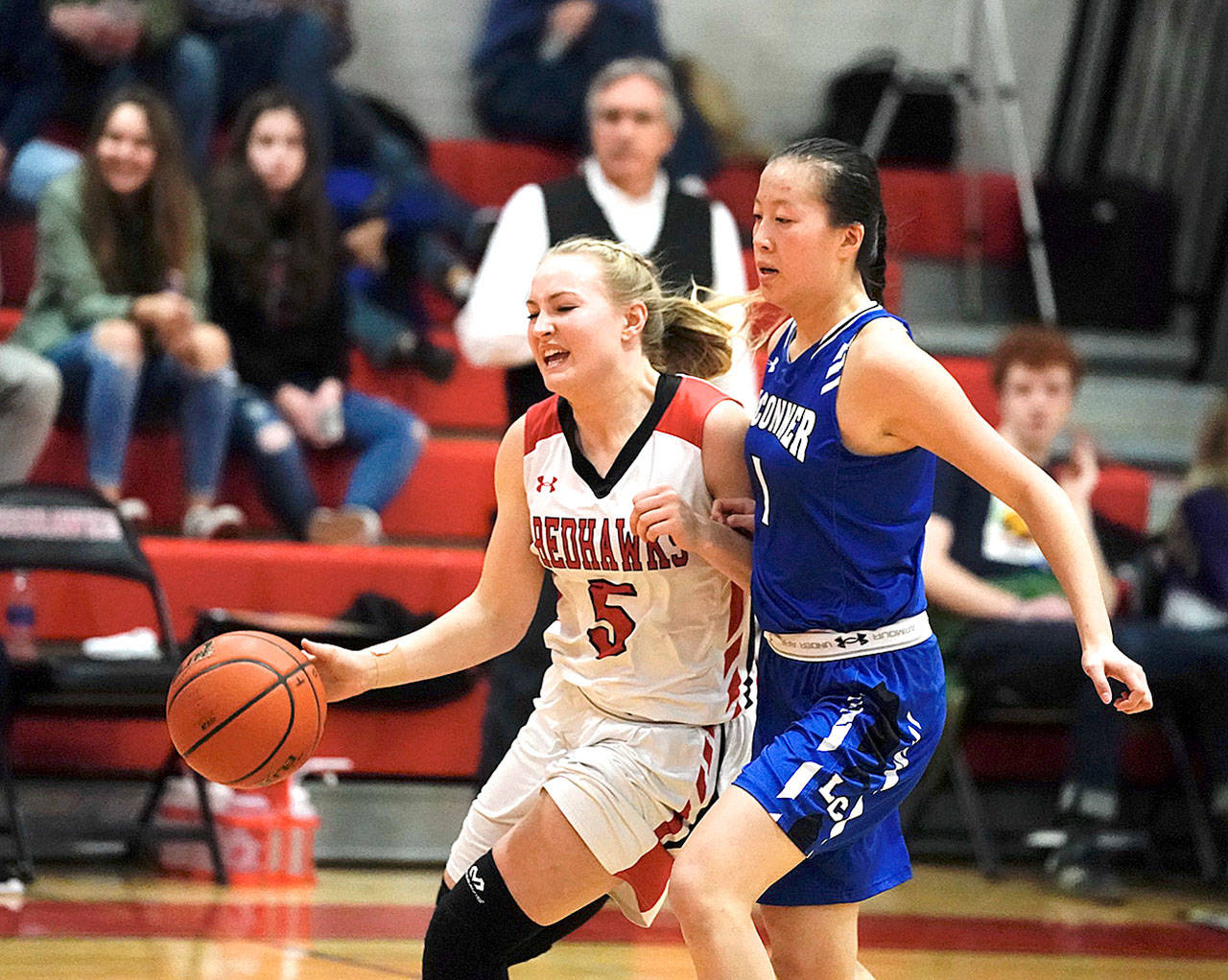 Port Townsend’s Kaitlyn Meek pushes her way around La Conner’s Matty Langerwey during a Crush in the Slush game on Saturday at the high school. In the background is Port Townsend head coach Scott Wilson. (Steve Mullensky/for Peninsula Daily News)