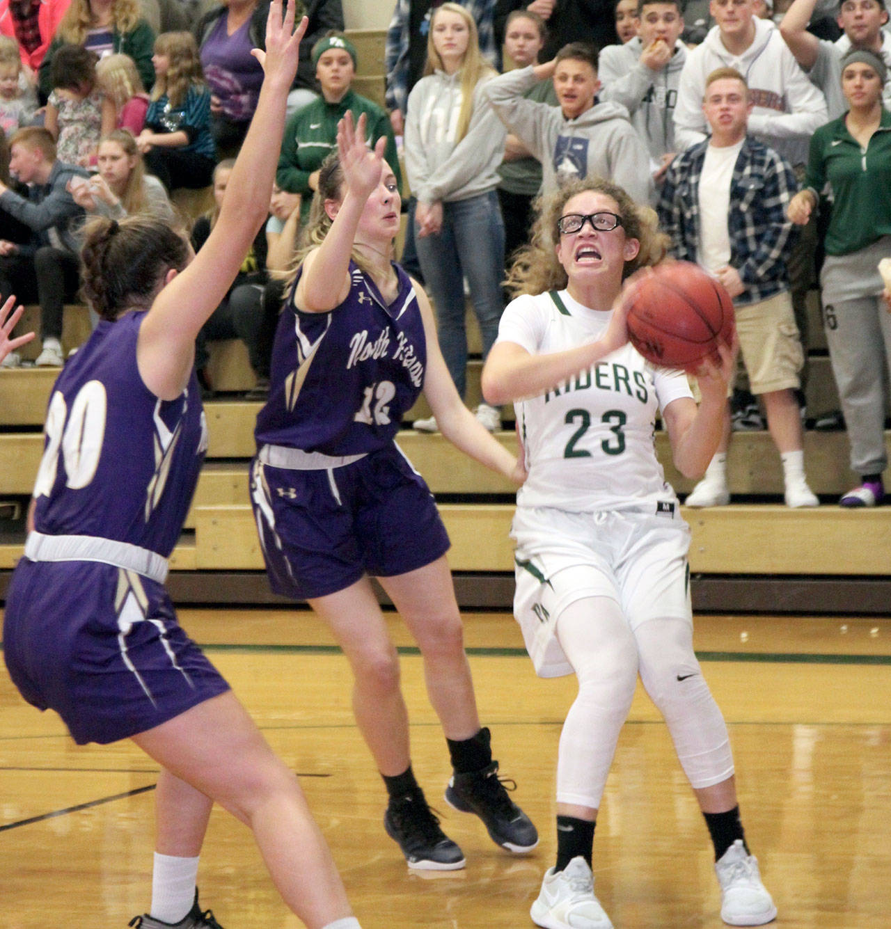 &lt;strong&gt;Dave Logan&lt;/strong&gt;/for Peninsula Daily News                                Port Angeles’ Madison Cooke (23) pulls up for a shot while guarded by North Kitsap’s Erin Pearson, left, and Grace Johnson.