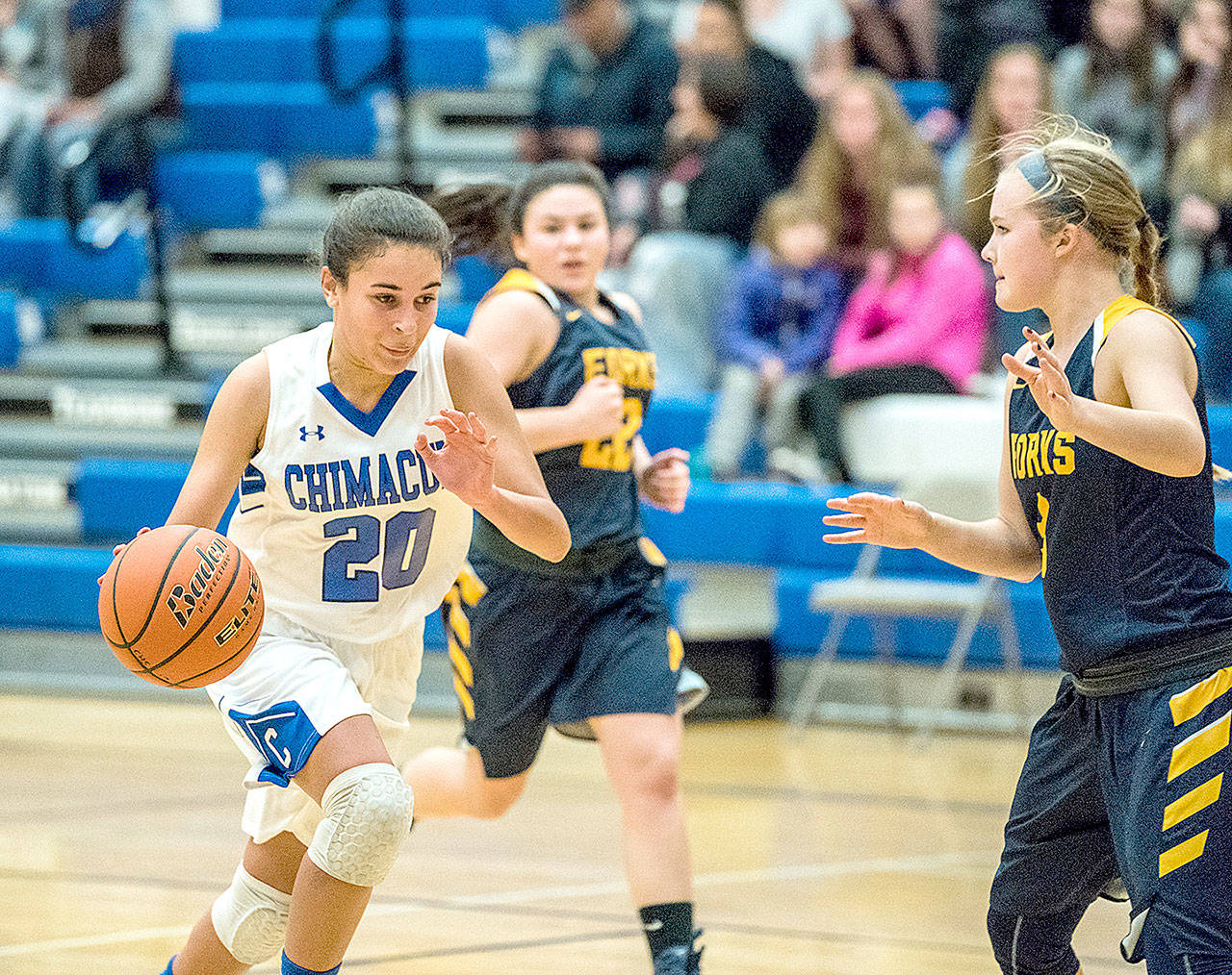 Chimacum’s Mia McNair (20) races around Forks’ Jayden Olson and to the basket during Tuesday’s game. The Forks girls came back from a big deficit to win 45-44 in overtime. (Steve Mullensky/for Peninsula Daily News)