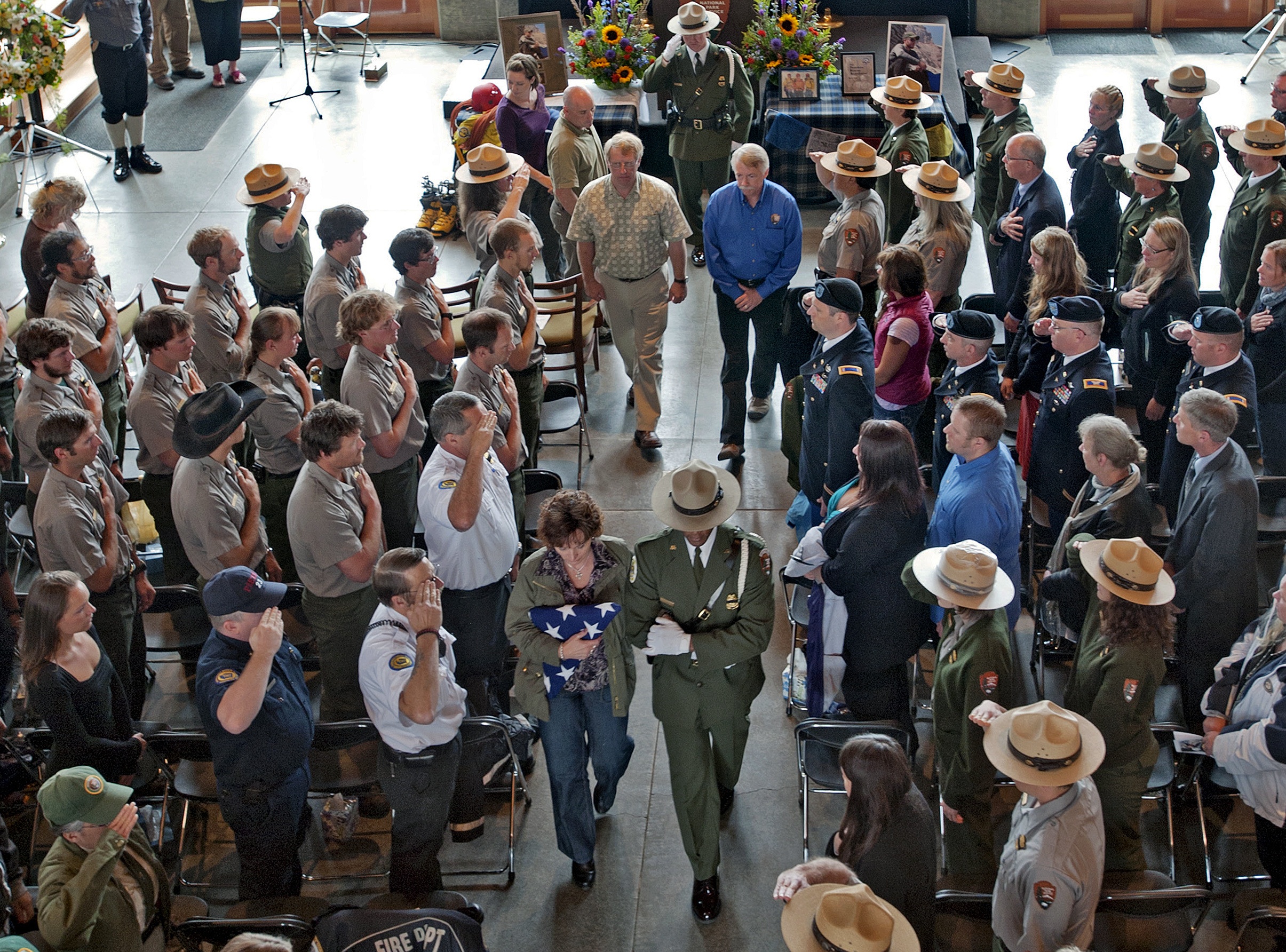 The family of Nick Hall is escorted from Friday's memorial service in the Jackson Visitor Center in Mount Rainier National Park. The ranger's mother