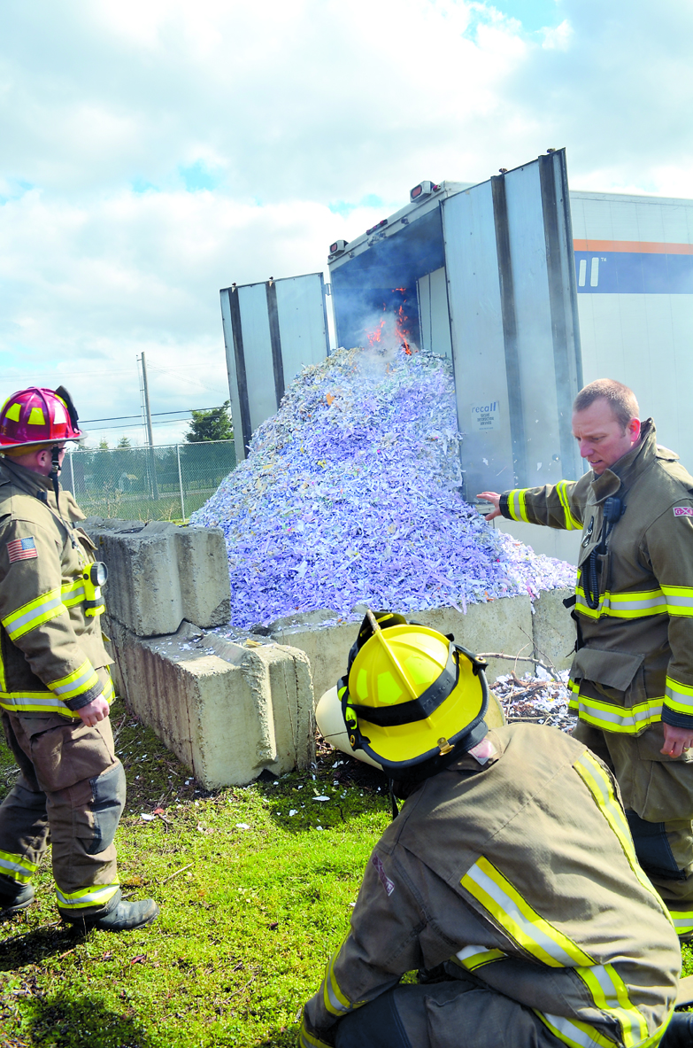 A commercial shredding truck with approximately 6