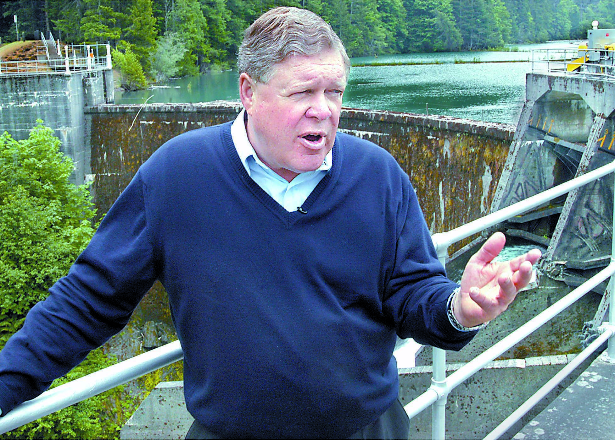 Rep. Norm Dicks stands at Glines Canyon Dam in Olympic National Park in 2004 to discuss financing of the Elwha River dam removals