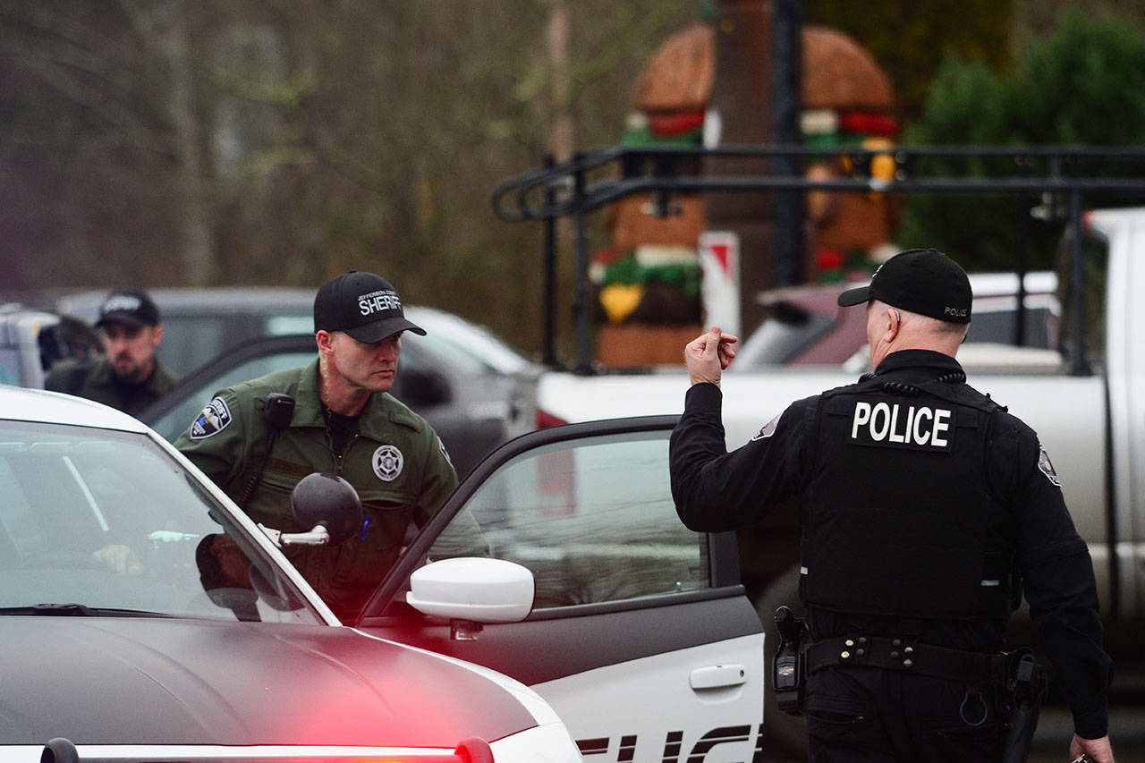 Jefferson County Sheriff’s deputies and Port Townsend police officers respond to U.S. Highway 101 and state Highway 20 Monday afternoon, where law enforcement arrested Hugo Madriz, 39, for eluding law enforcement the day before. (Jesse Major/Peninsula Daily News)