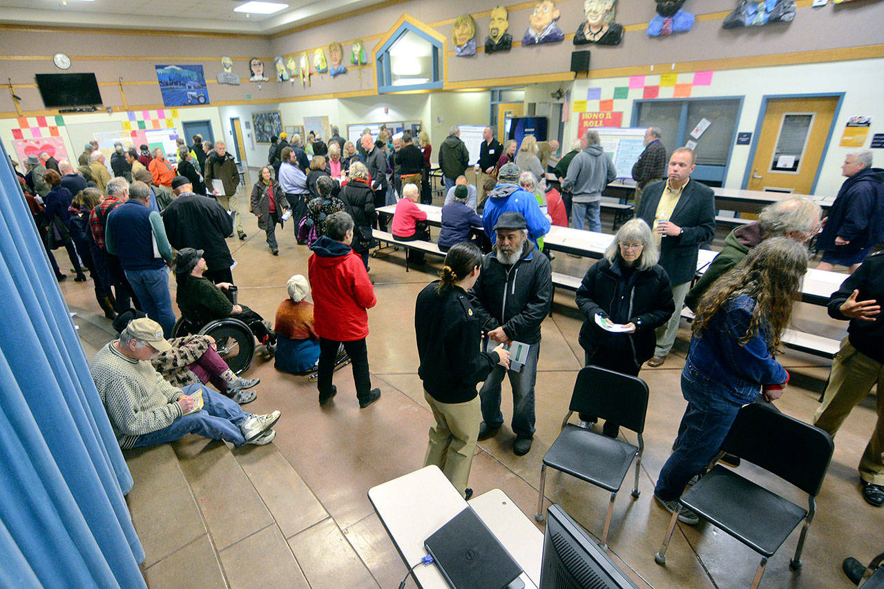 Dozens of people talk about the Navy’s proposed increase in training in the Puget Sound during an open house in Port Townsend on Wednesday evening. (Jesse Major/Peninsula Daily News)