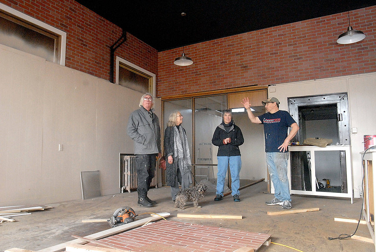 Port Angeles artists, from left, Bob Stokes, Cindy Elstrom and Mary Alice Long examine the space that will house the new Harbor Arts collective with building landlord John Hammond on Friday. The storefront at 114 N. Laurel St., in downtown Port Angeles will replace the Railroad Avenue building currently used for Harbor Arts in light of plans for a hotel by the Lower Elwha Klallam Tribe. (Keith Thorpe/Peninsula Daily News)