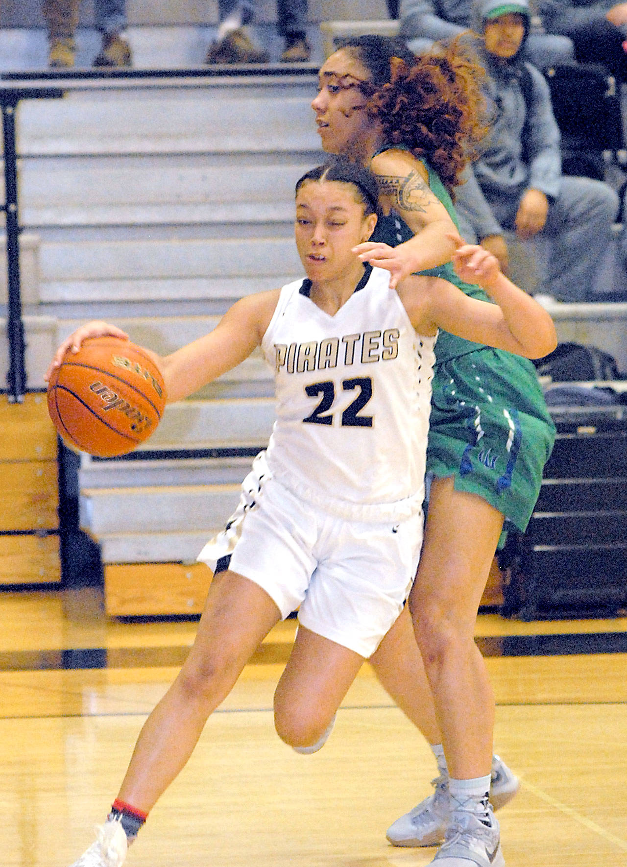 Keith Thorpe/Peninsula Daily News Peninsula’s Tiffani Smith, left, slips past Edmonds’ Tiara Tupua on Saturday on the Pirate home court in Port Angeles.