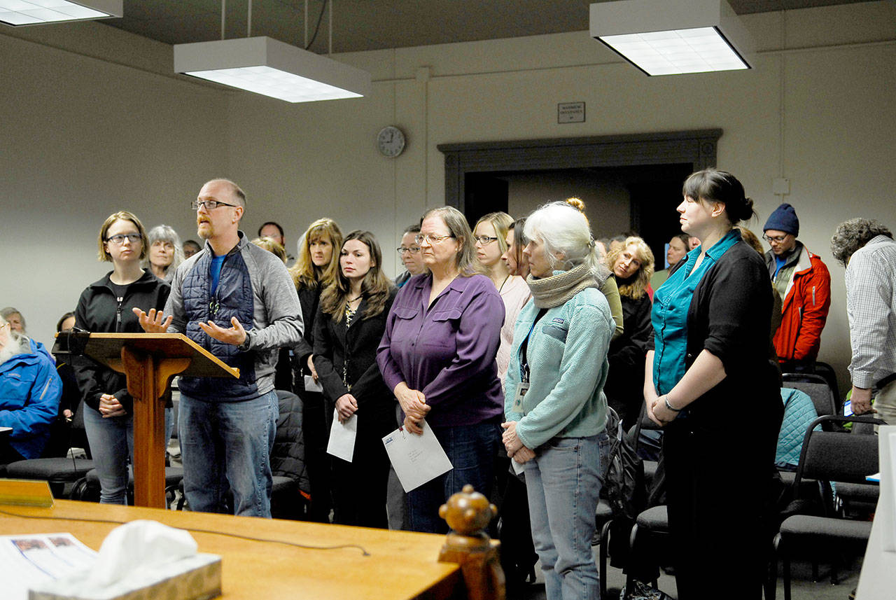 Members of Jefferson County Employees UFCW 21 address the county commissioners. Their contract expired in December 2017. Brad Stone, center, presented a signed petition with comments about the contract from 75 union members. (Jeannie McMacken/Peninsula Daily News)