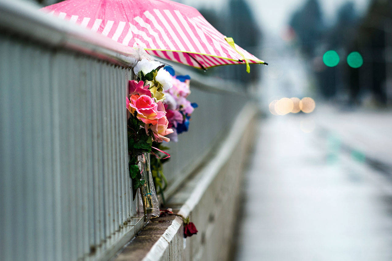 Flowers lean against the rail of the eastern Eighth Street bridge Thursday. With an anticipated $350,000 in funding coming from the state, Port Angeles say they can complete the fencing project on both bridges this summer. (Jesse Major/Peninsula Daily News)