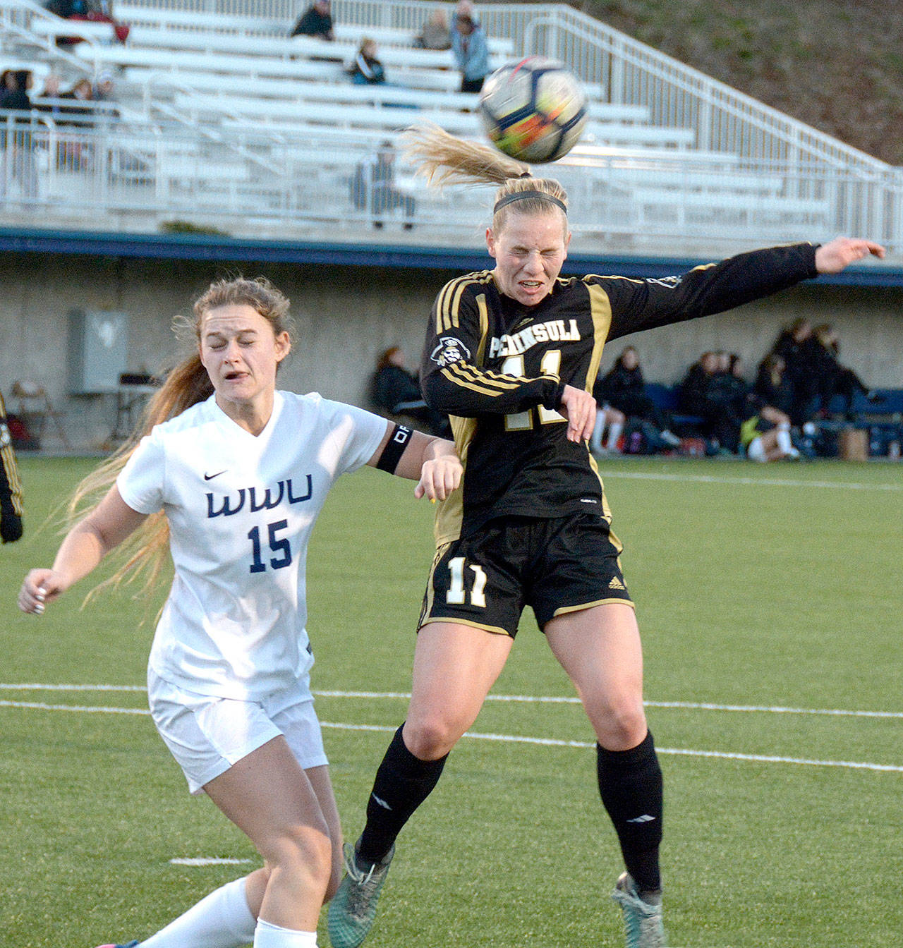 Peninsula’s Maddy Parton, guarded by Western Washington’s Sophia Kallas, heads the ball in a friendly match Saturday in Bellingham. Peninsula won the match 2-0. (Rick Ross)