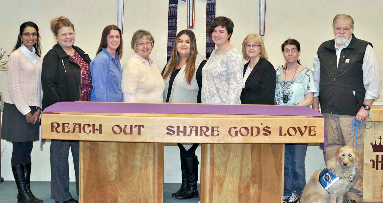 Receiving checks from the Dungeness Valley Lutheran Church on March 29 were, from left, Priya Jayadev, executive director, Clallam Mosaic; Rebekah Miller, development associate, Peninsula Behavioral Health; Nicole Brewer, executive director, First Teacher; Linda DeMoss, vice president, Sequim Community Aid; Maria Davila, shelter manager, and Katie Spooner, victim advocate, both of Forks Abuse Program; Carol Pope, North Olympic Foster Parent Association; Klara Murray, volunteer, and John Braasch, president, both of Voices for Veterans, with Braasch’s service dog Sadie.