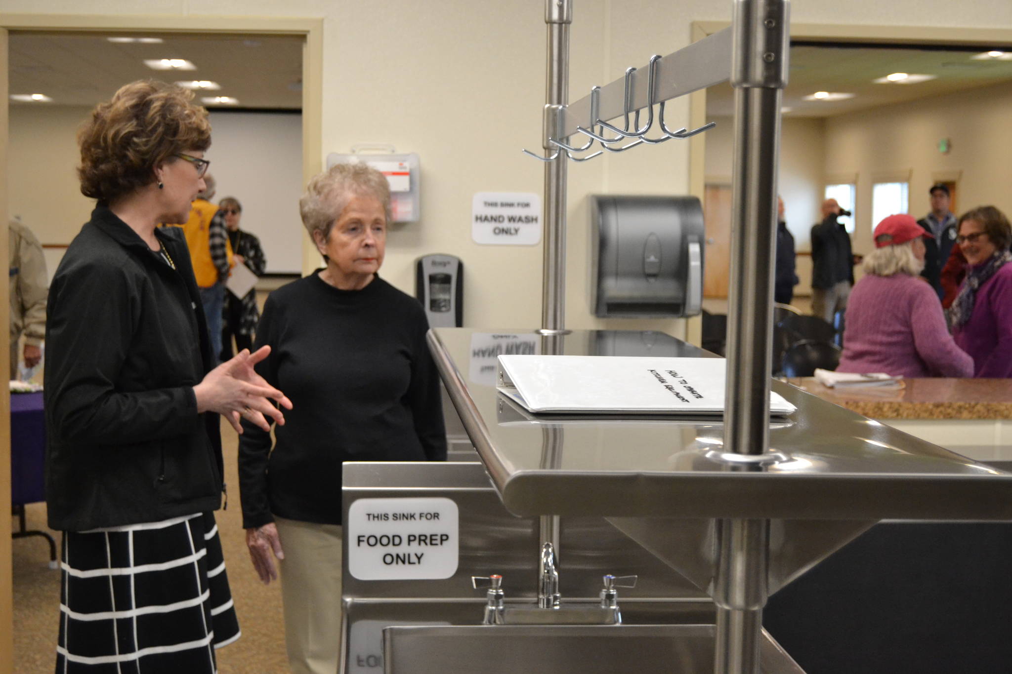 Sarah Van Ausdle, public works management analyst, on left, shows Arlene Rayniak of Sequim what’s new inside the Guy Cole Events Center’s kitchen last Wednesday. The city of Sequim used a state grant to fund a portion of the remodel. (Matthew Nash/Olympic Peninsula News Group)