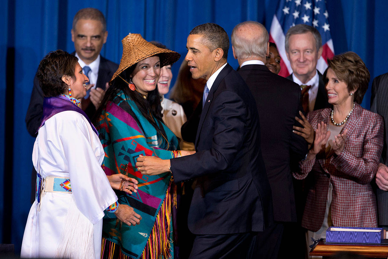 In this March 7, 2013, file photo, President Barack Obama greets Our Sister’s Keeper Executive Director Diane Millich, from left, and Tulalip Tribes of Washington State Vice Chairwoman Deborah Parker, after signing the Violence Against Women Act in Washington, D.C. Five years after a federal law gave tribes authority over non-Natives for some domestic violence crimes, public safety advocates say communities are empowered to report wrongdoing and governments are working better together. (Manuel Balce Ceneta/The Associated Press)