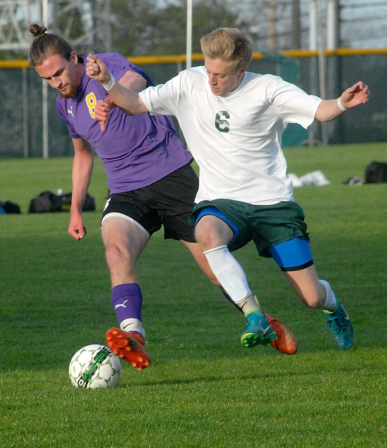 Sequim’s Liam Harris, left, and Port Angeles’ Ben Schneider battle for control in the first half on Tuesday evening at Port Angeles Civic Field. (Keith Thorpe/Peninsula Daily News)