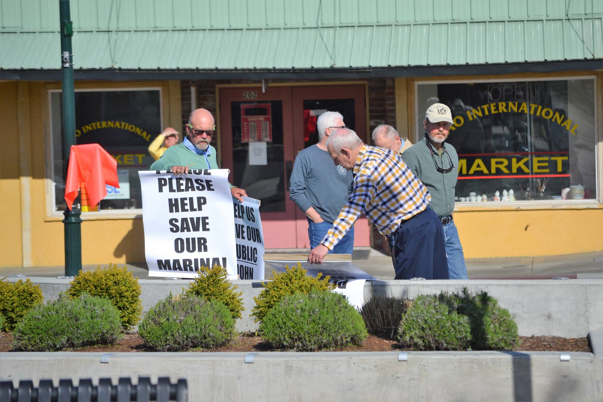 Community members gather with signs prior to this week’s Sequim City Council meeting. (Matthew Nash/Olympic Peninsula News Group)