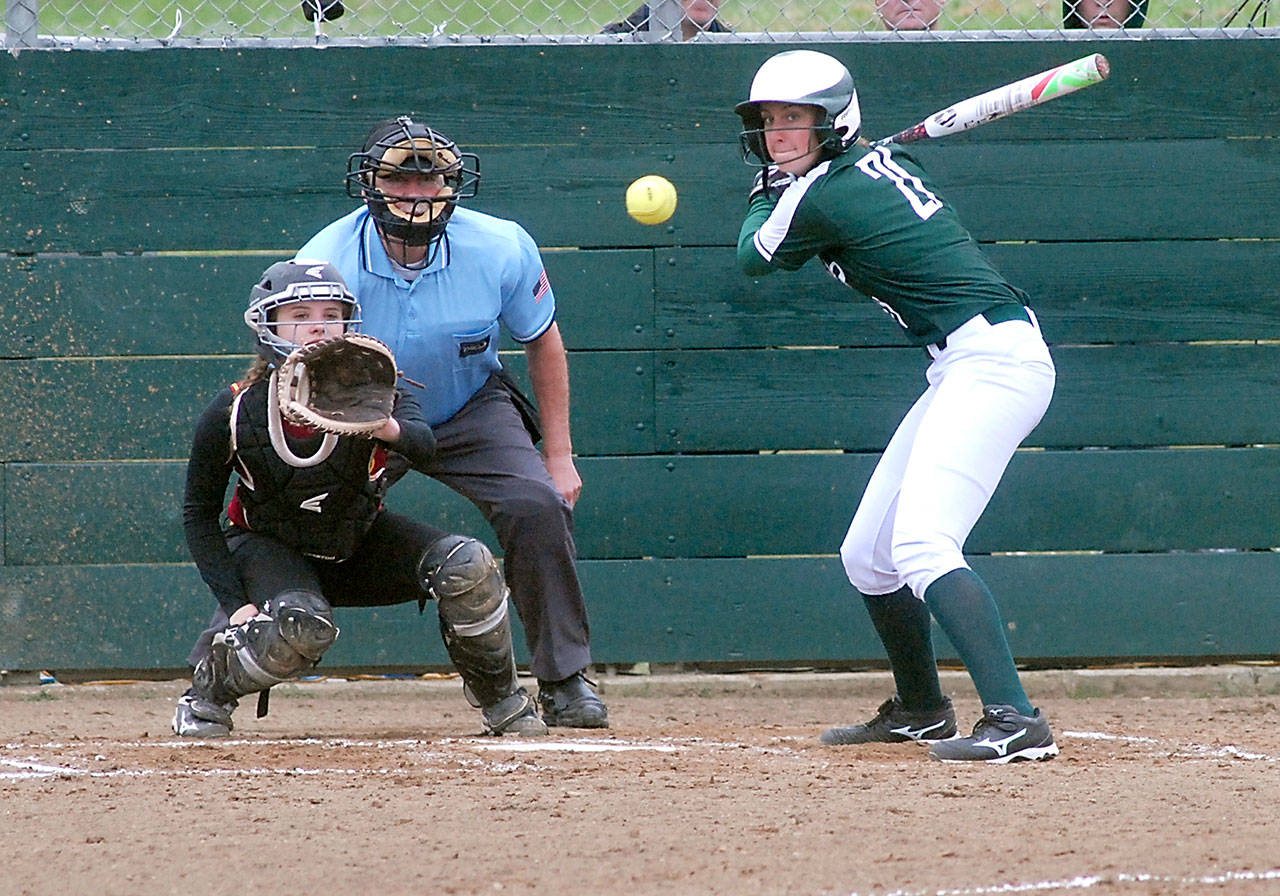 Keith Thorpe/Peninsula Daily News                                Port Angeles’ Erin Edwards watches the delivery to Kingston catcher Meghan Fenwick in the first inning on Wednesday at the Dry Creek athletic fields in Port Angeles. Edwards hit a three-run home run in her at-bat.