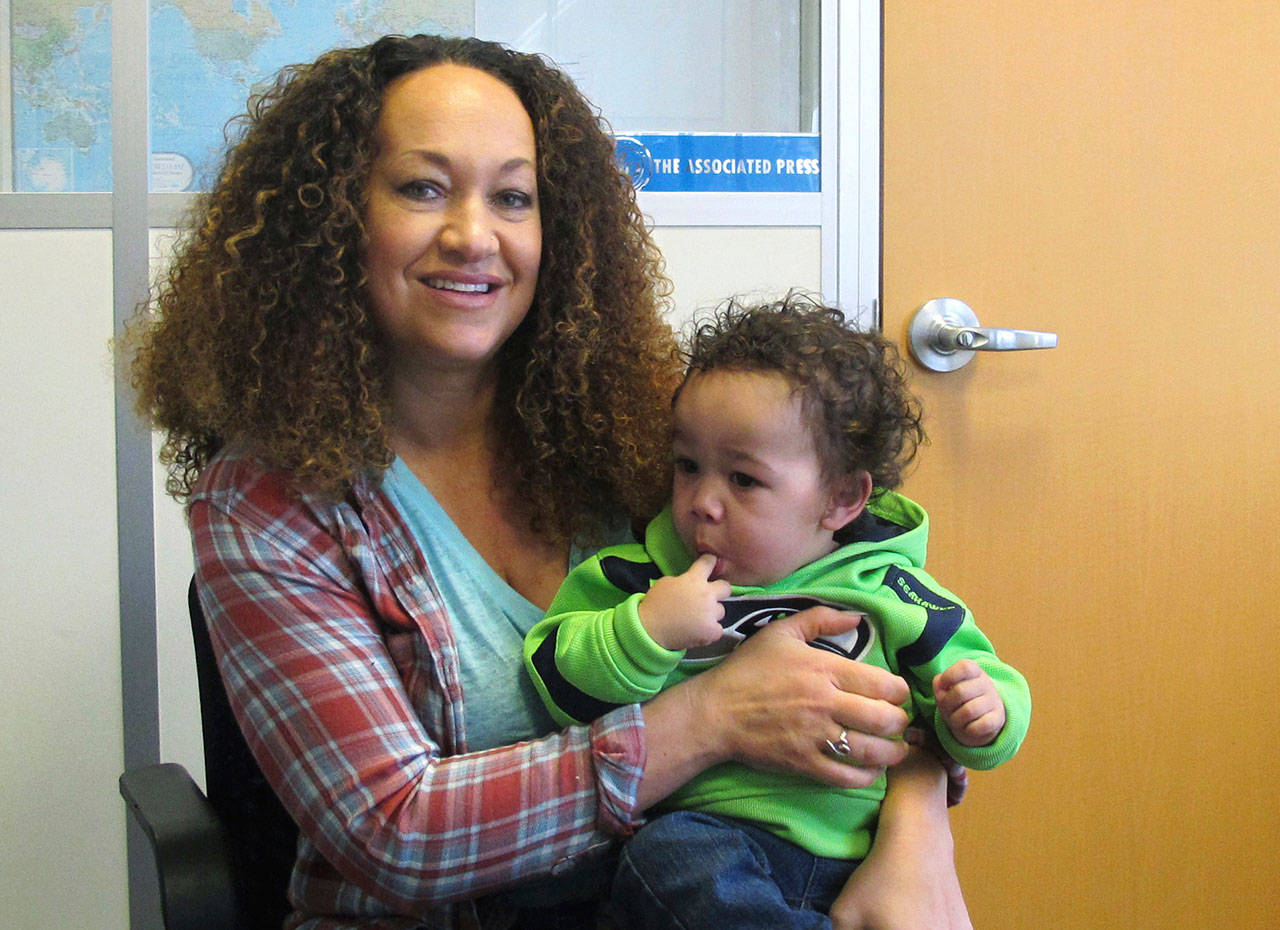 In this March 20, 2017, file photo, Rachel Dolezal poses for a photo with her son, Langston, at the bureau of The Associated Press in Spokane. (The Associated Press)