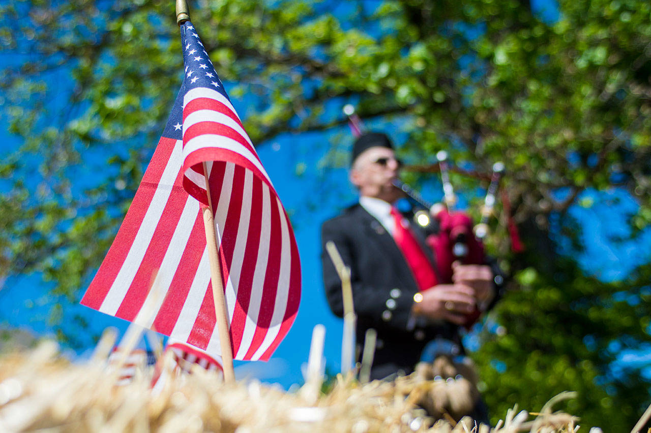 Retired Coast Guardsman Ricky McKenzie performs during the Captain Joseph House Memorial service Sunday. (Jesse Major/Peninsula Daily News)