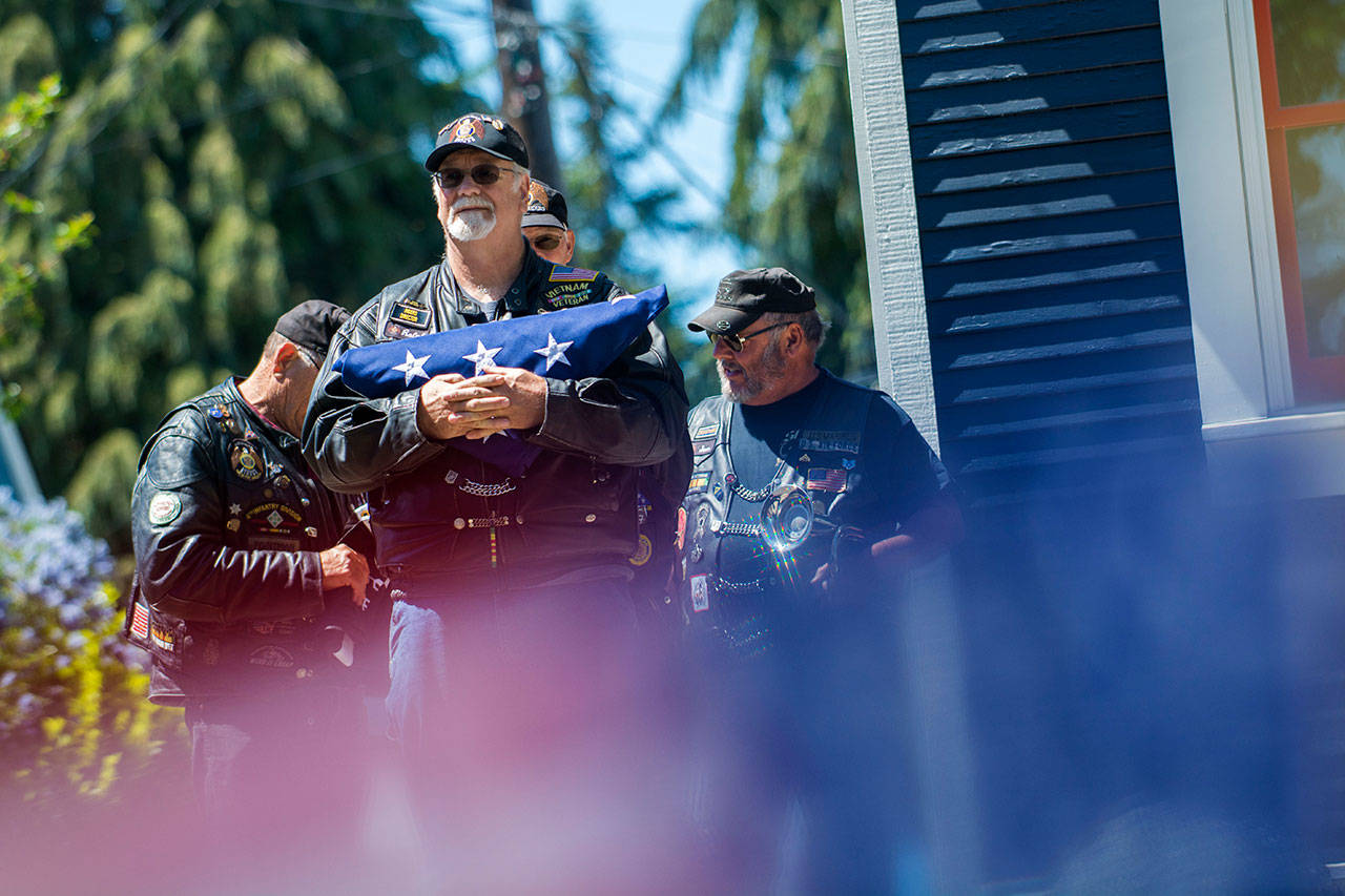 American Legion Riders from Post No. 29 prepare to raise the American flag during the Captain Joseph House Memorial service on Sunday. (Jesse Major/Peninsula Daily News)