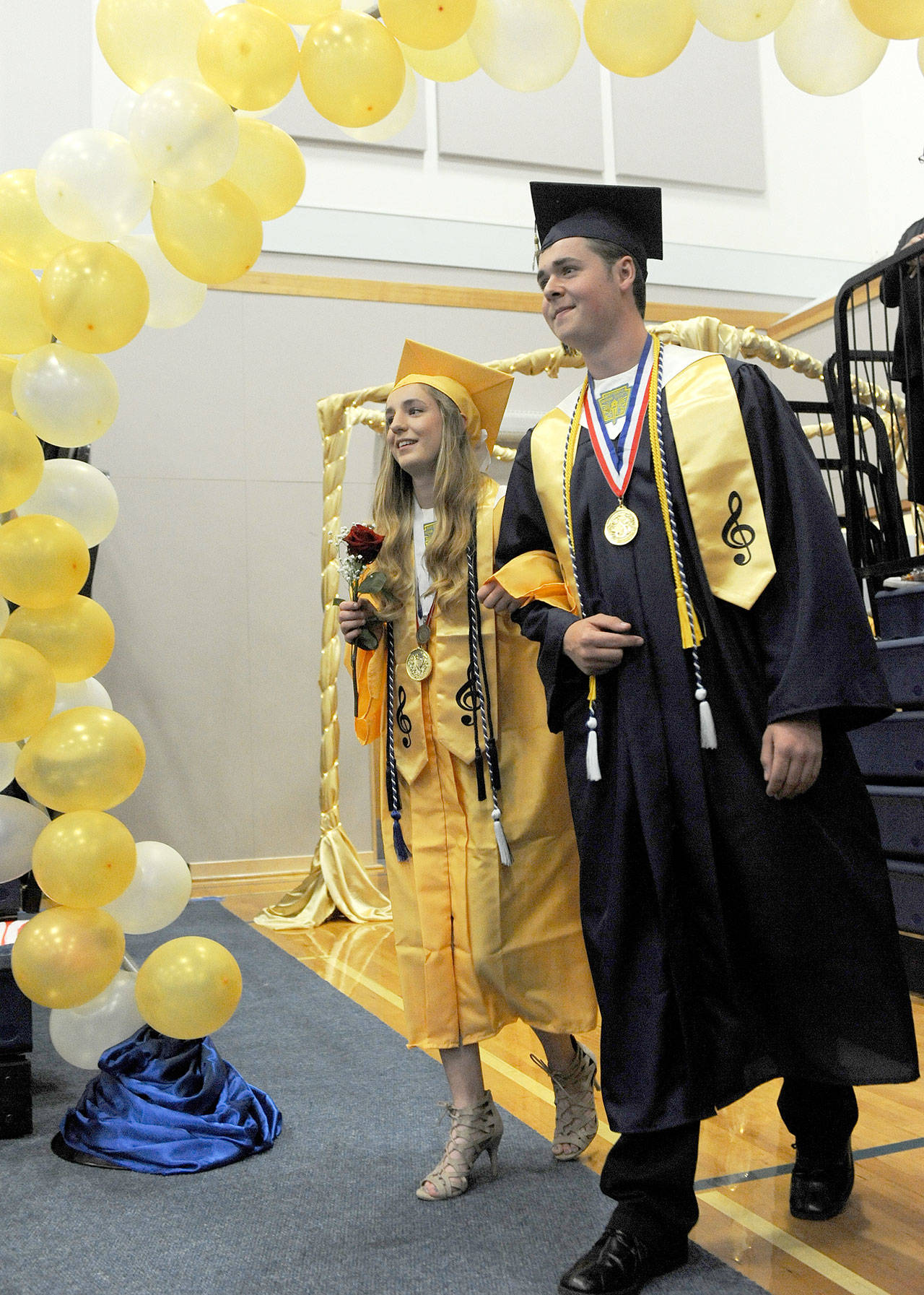 Forks High School valedictorian Marissa Bailey and salutatorian Scott Archibald lead the Pomp and Circumstance march into the Forks Spartan gym Saturday evening during the graduation ceremony. (Lonnie Archibald/for Peninsula Daily News)