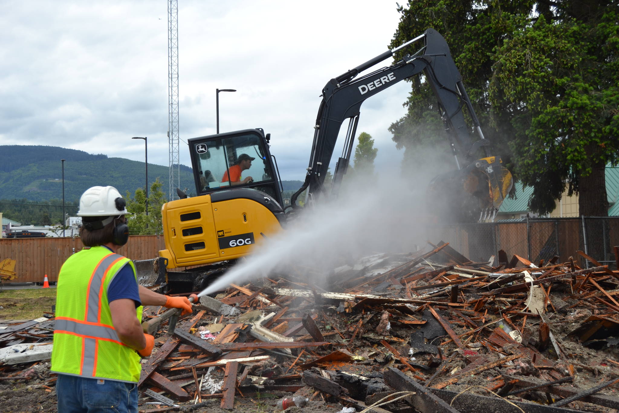 A crew during Service Fest demolish a home at 169 W. Spruce St. The city of Sequim partnered with its homeowner to demolish it. (Matthew Nash/Olympic Peninsula News Group)