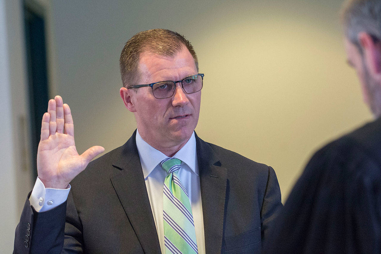 Martin Brewer is sworn in as Port Angeles School District’s next superintendent during the district’s school board meeting on Thursday. (Jesse Major/Peninsula Daily News)