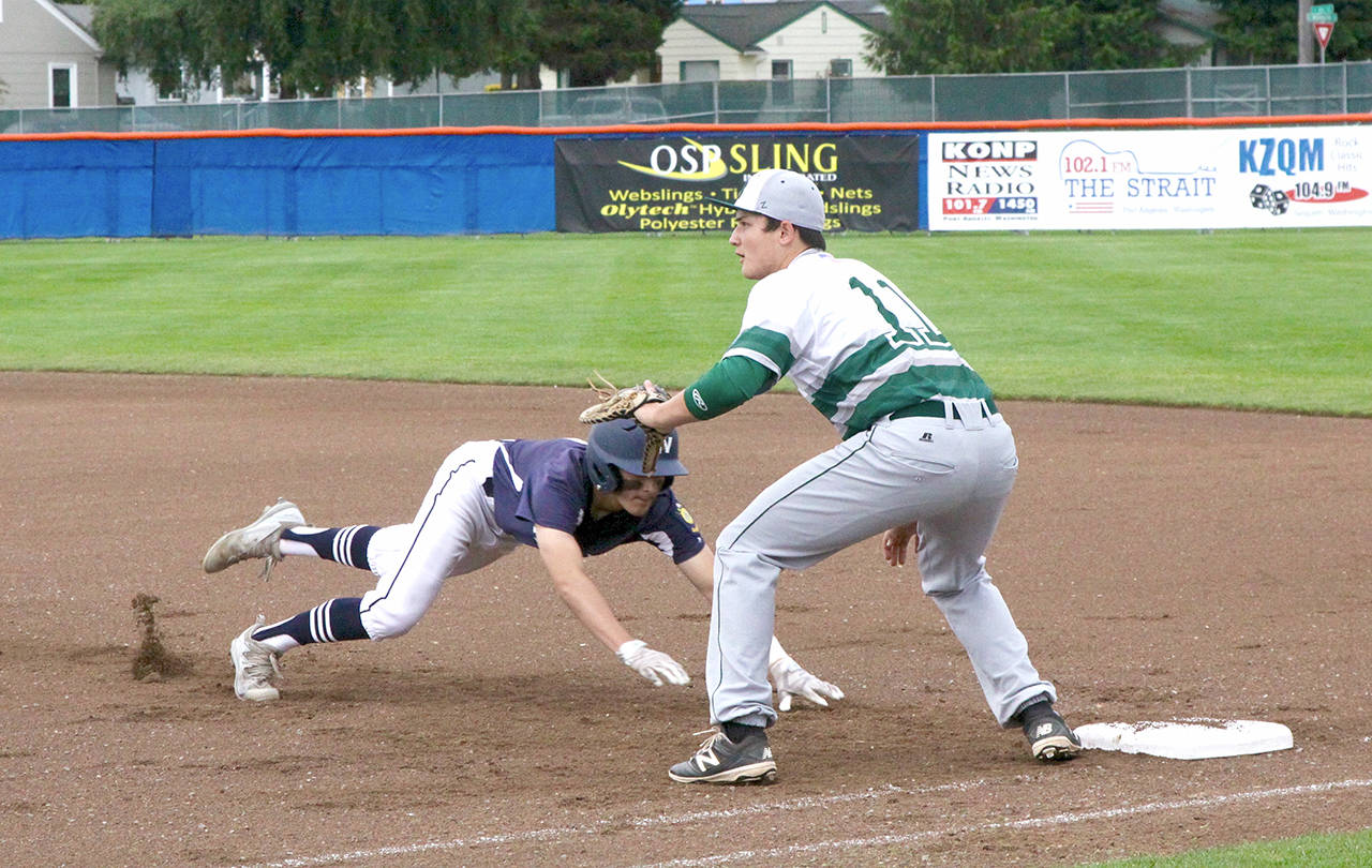 Wilder’s Tyler Bowen dives back to first base during Wilder’s 13-0 win over Lakeside Recovery at Civic Field on Friday night. Bowen stole two bases and drove in three runs in the win. (Dave Logan/for Peninsula Daily News)