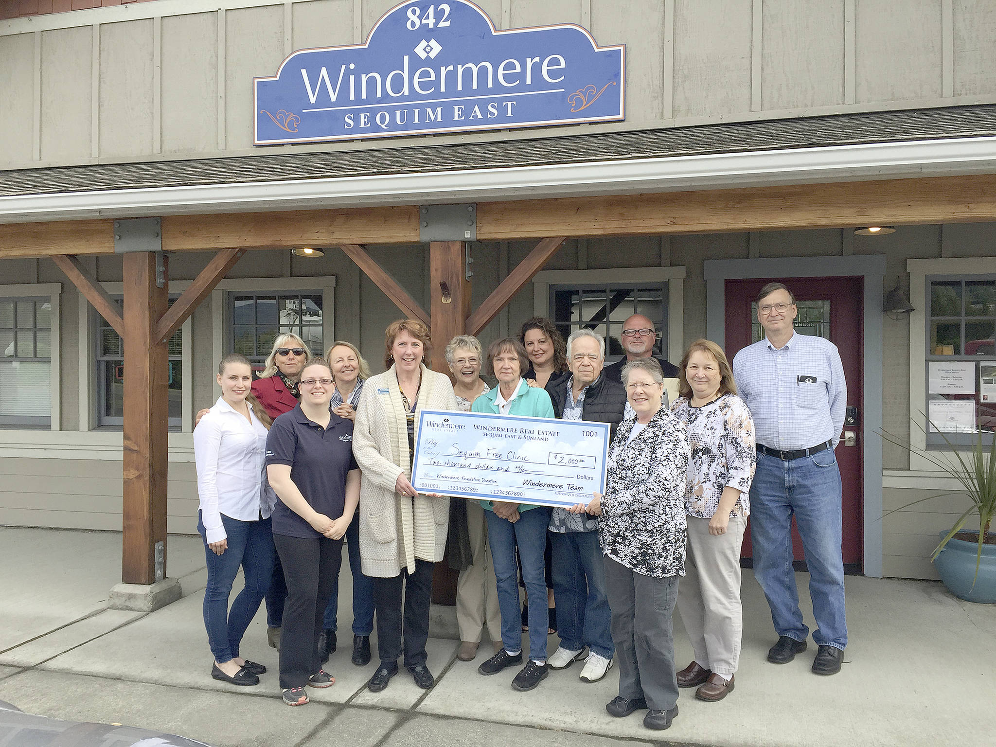 From left, Christina Schwyn, Jody McLean, Jessica Warriner, Marcee Medgin, Sequim Free Clinic Executive Director Sara Nicholls, Carolyn Dodds, Carol Dana, Dollie Sparks, Dave Sharman, Rick Brown, Deb Kahle, Sheryl Payseno Burley and Robert Dodds. (Windermere Real Estate)