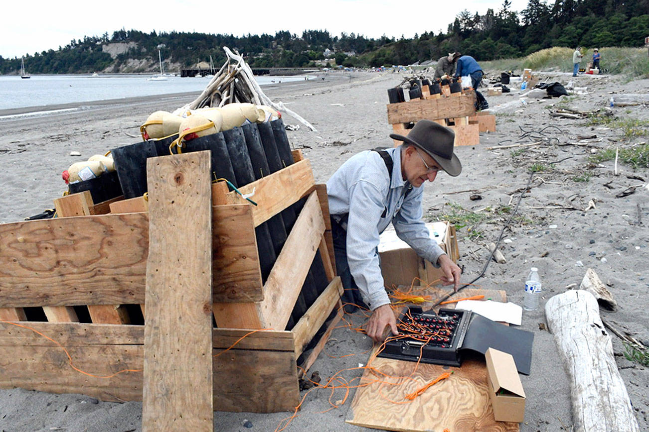 Pyrotechnician David Chuljian sets firing mechanisms with his team as they prep on Wednesday afternoon for the fireworks display finale of the The Old School 4th of July at Fort Worden. By his count, Chilean said there are 232 large and medium-sized mortars and several smaller ones worth 15 minutes of booms and flash. He’s been lighting off fireworks, legally, for 35 years. (Jeannie McMacken/ Peninsula Daily News)