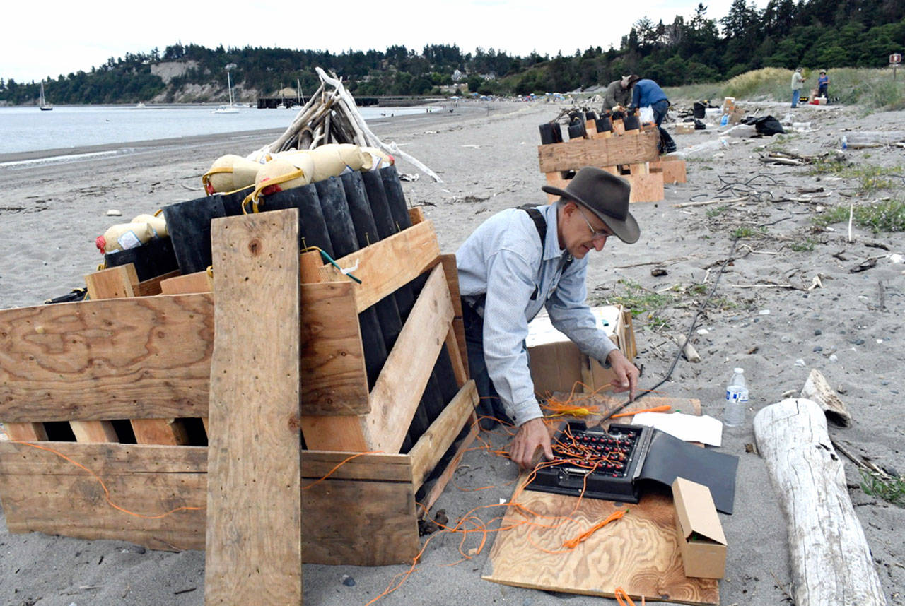 Pyrotechnician David Chuljian sets firing mechanisms with his team as they prep on Wednesday afternoon for the fireworks display finale of the Old School 4th of July at Fort Worden. By his count, Chuljian said there are 232 large and medium-sized mortars and several smaller ones worth 15 minutes of booms and flash. He’s been lighting off fireworks, legally, for 35 years. (Jeannie McMacken/Peninsula Daily News)