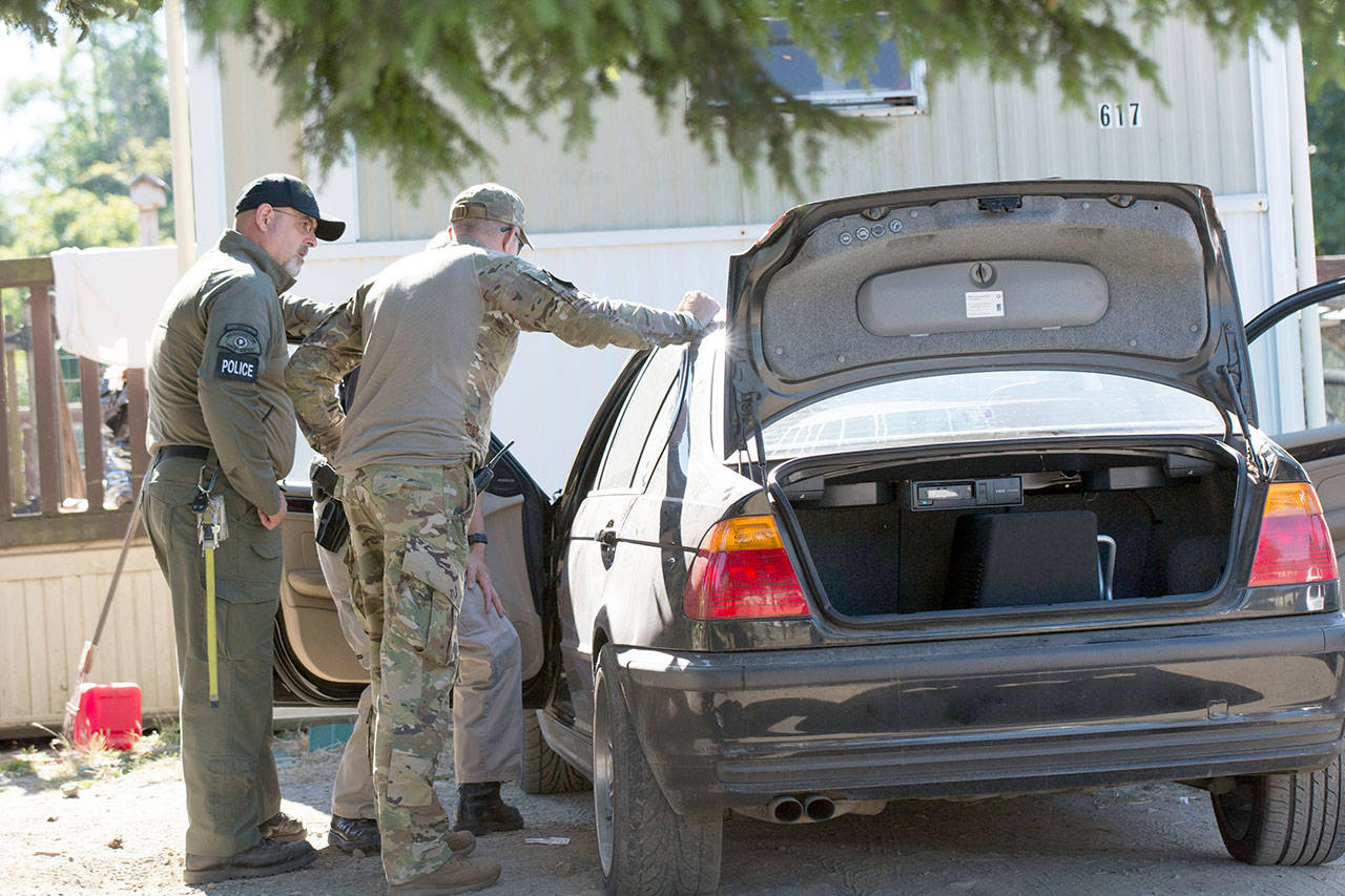 Law enforcement serve a search warrant at a suspected drug house on North Larch Avenue in Port Angeles. (Jesse Major/Peninsula Daily News)