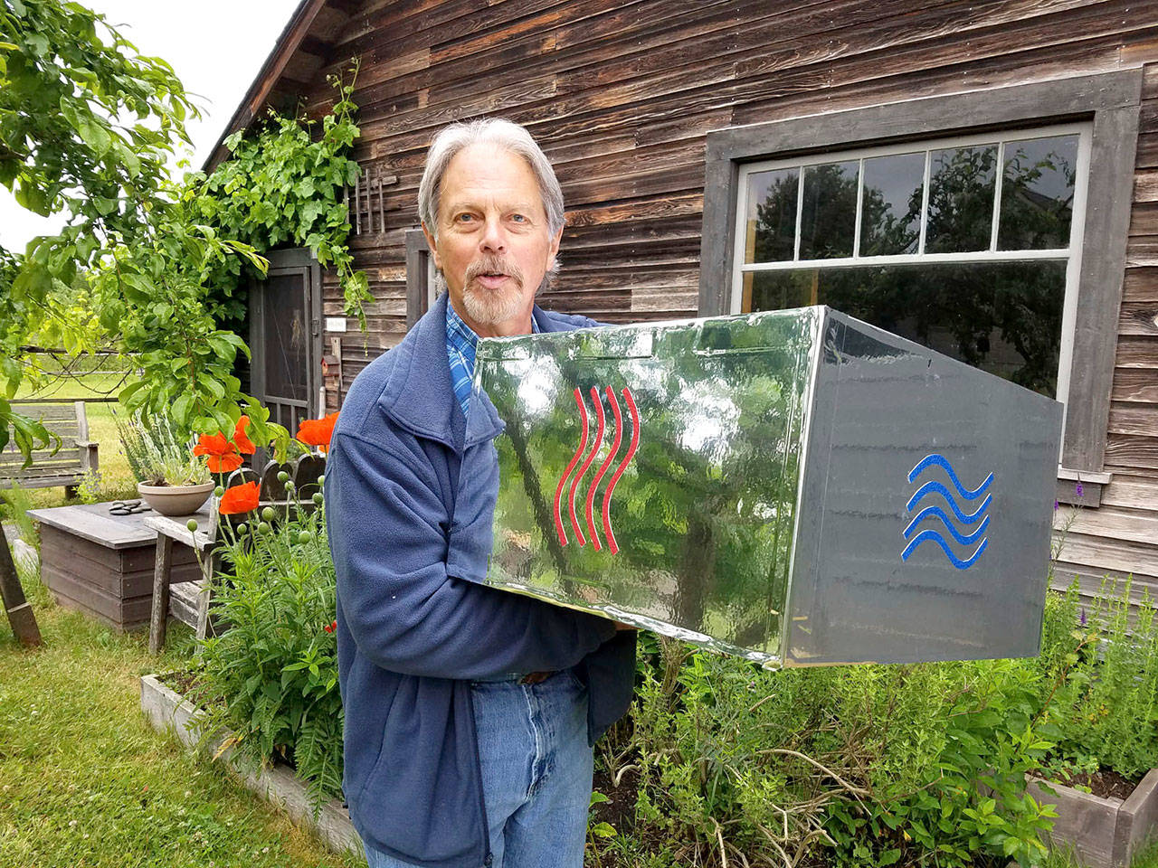 Brian Buntain holds a section of the “Fifth Element” totem pole which will be central to this year’s Art Jam exhibit at Rock Hollow Farm in Sequim.