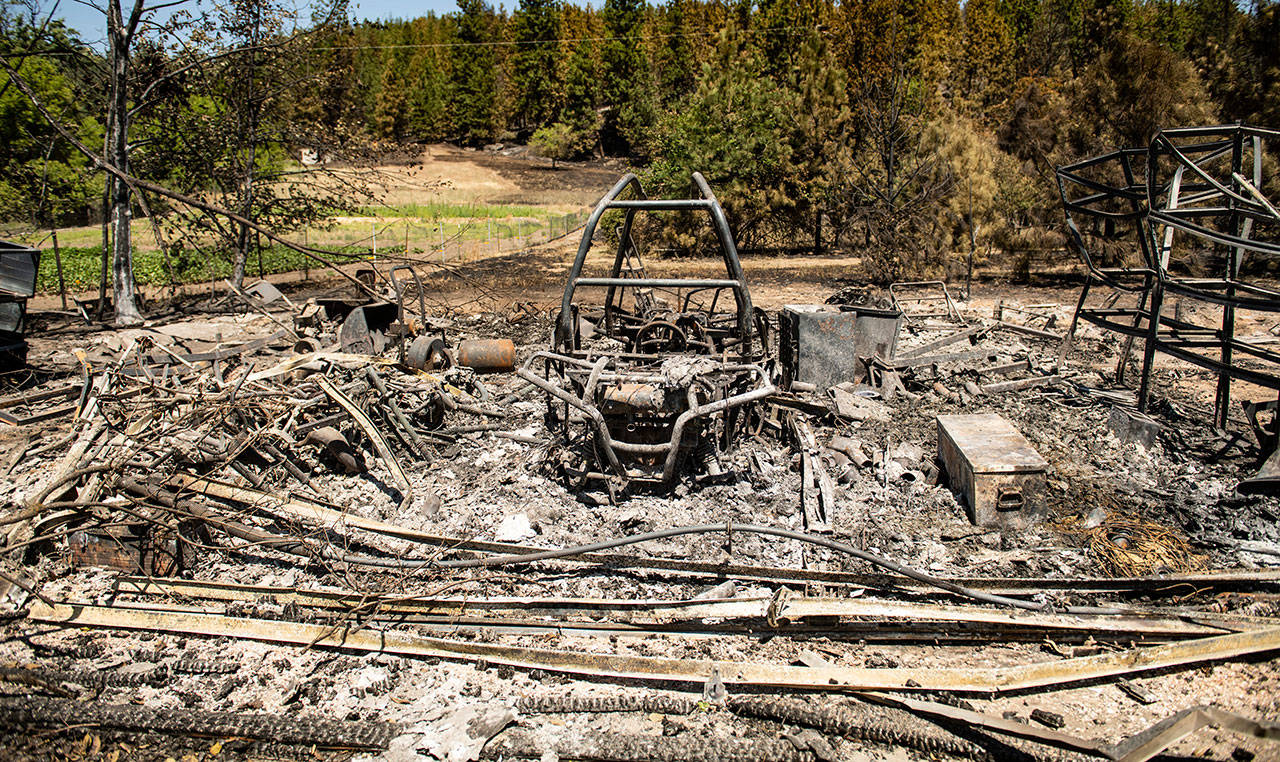 Just north of Upriver Drive, charred remains is all that is left of this garage Wednesday that burned during Tuesday’s wildfire. (Colin Mulvany/The Spokesman-Review via AP)