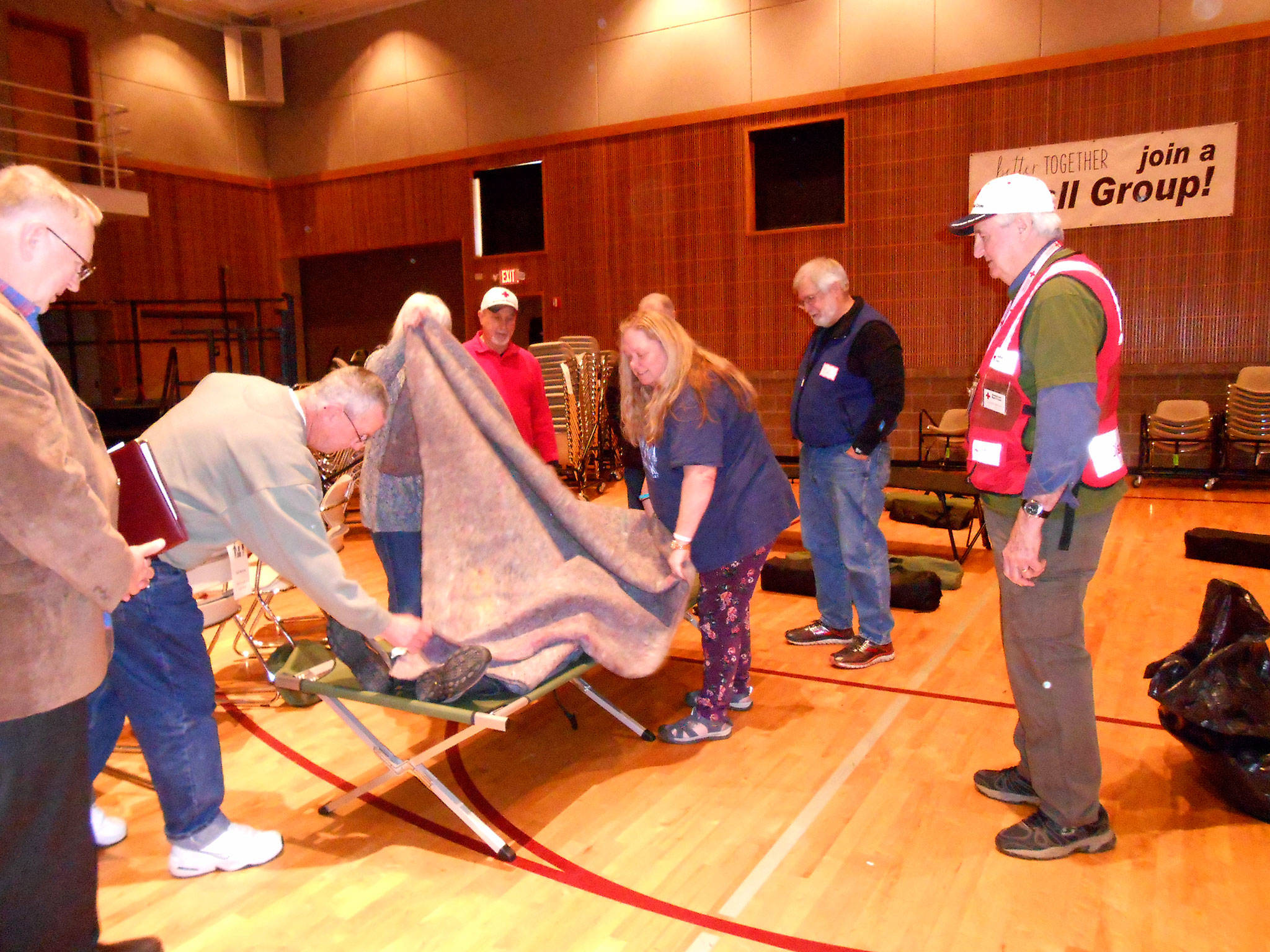 Volunteers with the Red Cross of Kitsap and Olympic Peninsulas help a trainee during a recent Shelter Training event. The local chapter in Carlsborg recently consolidated into one suite and volunteers seek space to store resources across Clallam County. (Deb Wozniak)