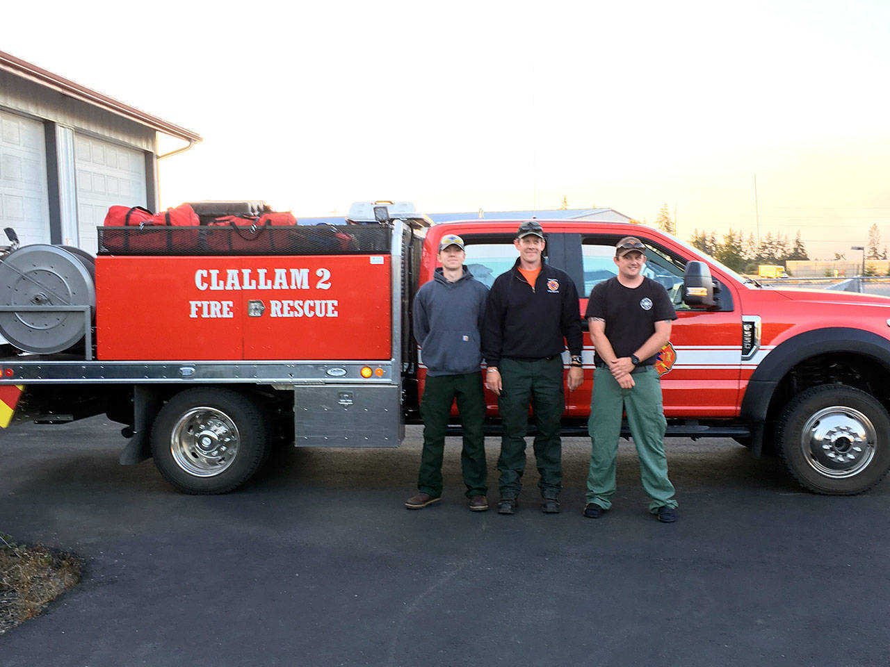 Firefighters, from left, Sam Orr, Steve Bentley and Tyler Reid head out to the Silver Lake Fire near Cheney. (Clallam 2 Fire Rescue)