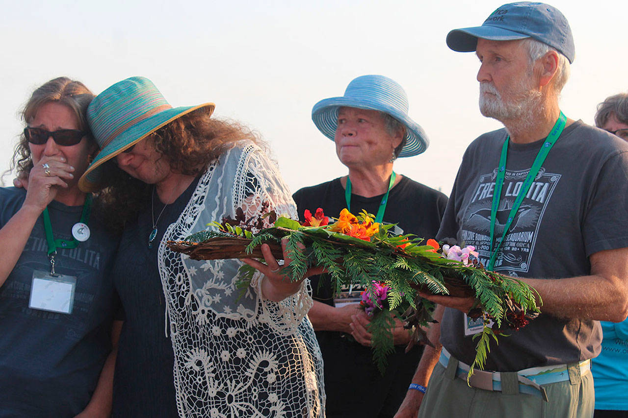 Honoring orcas captured in Penn Cove in the 1960s and ’70s and the lone survivor, Tokitae, are Cindy Hansen, far left, Susan Berta, Jan Bell, center, and Howard Garrett. The annual ceremony was held Aug. 8 at the wharf in Coupeville. (Patricia Guthrie/Whidbey News-Times)