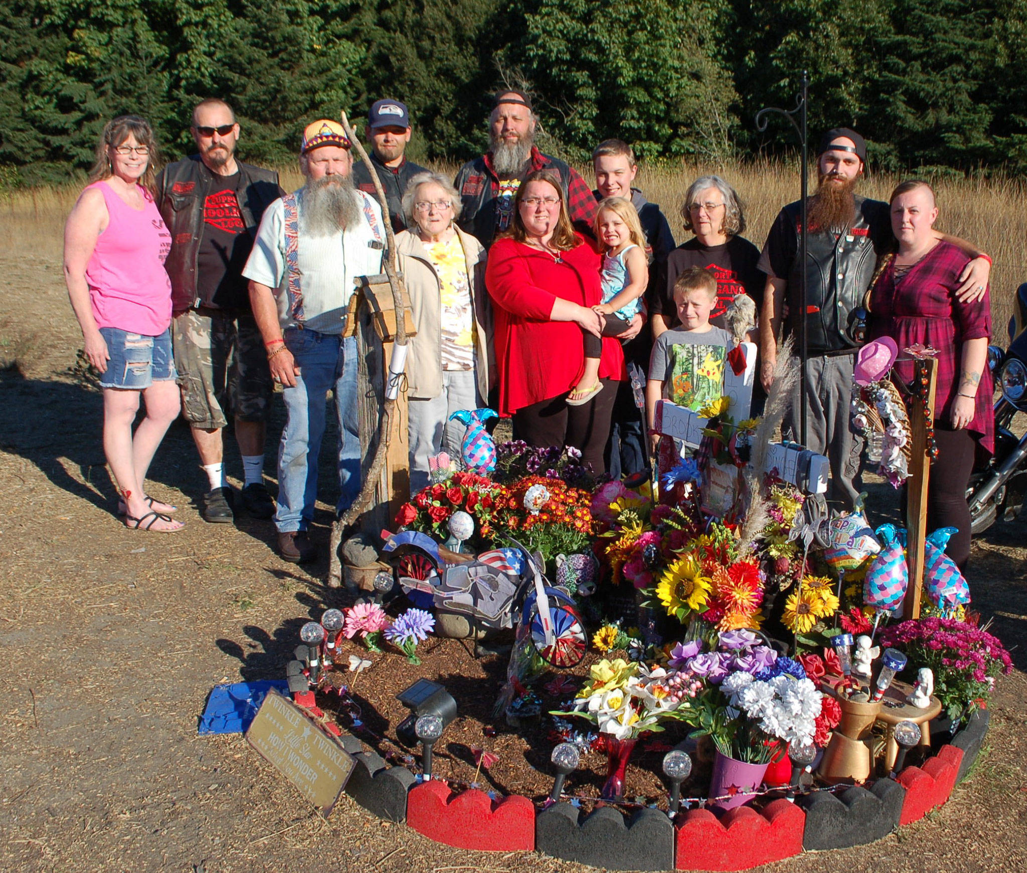 Brooke Bedinger’s family stands at her memorial on the side of U.S. Highway 101. (Erin Hawkins/Olympic Peninsula News Group)