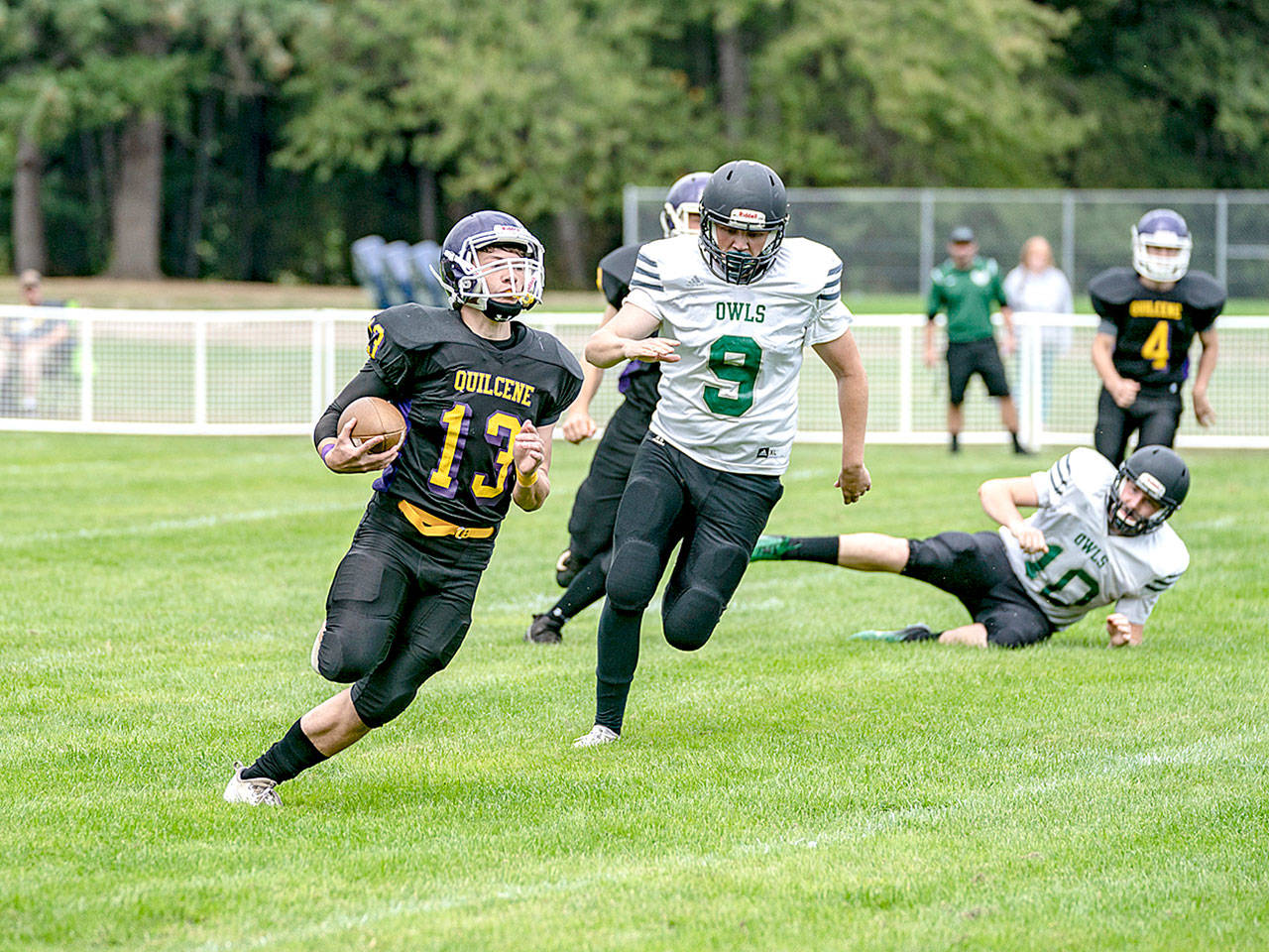 Steve Mullensky/for Peninsula Daily News Quilcene’s Olin Reynolds breaks around Mary M Knight’s Austin Nelson for a first down during the Rangers’ 54-38 win Saturday.