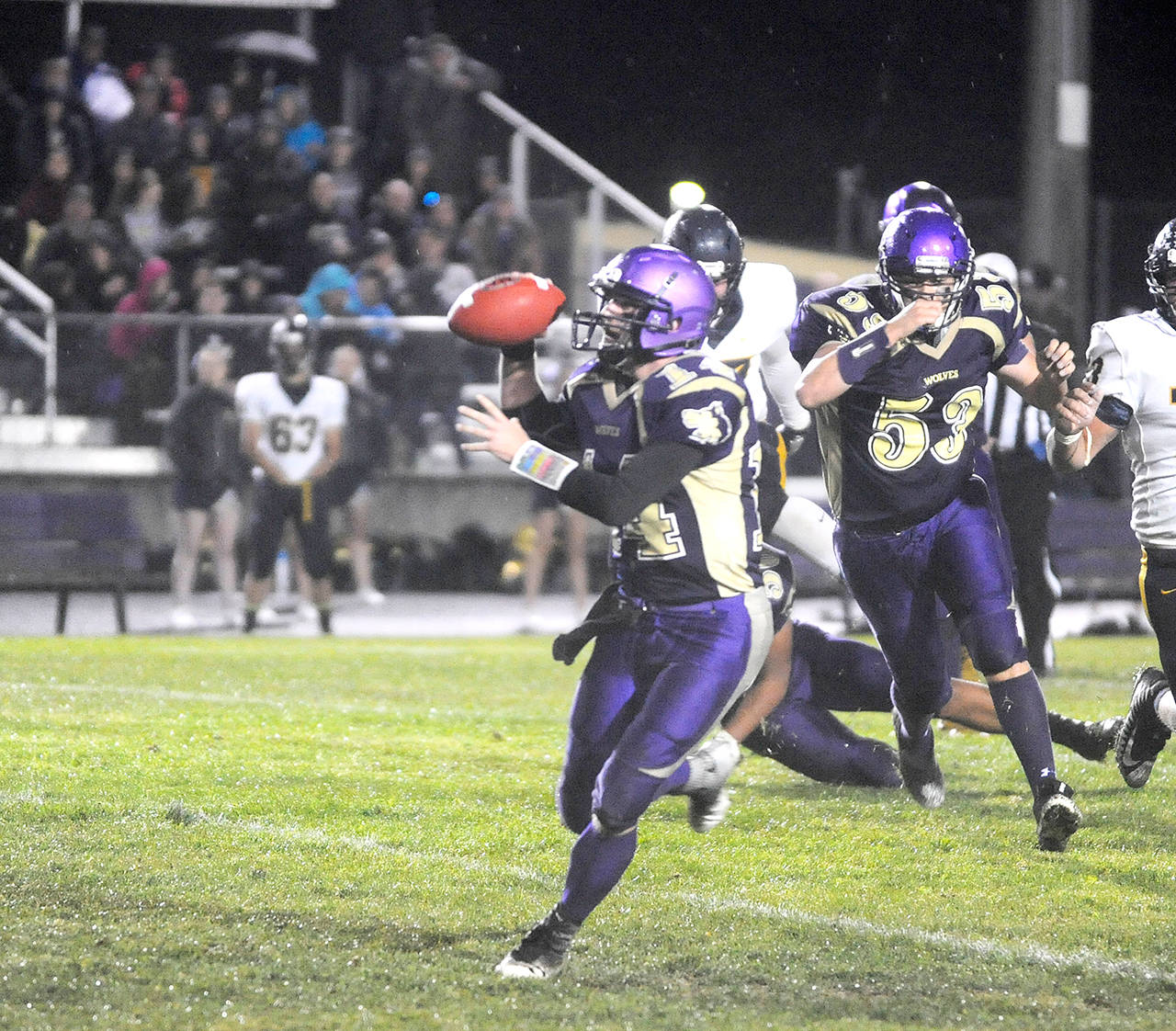 Michael Dashiell/Olympic Peninsula News Group Sequim quarterback Riley Cowan fakes a throw up the field during last week’s come-from-behind win over Forks.