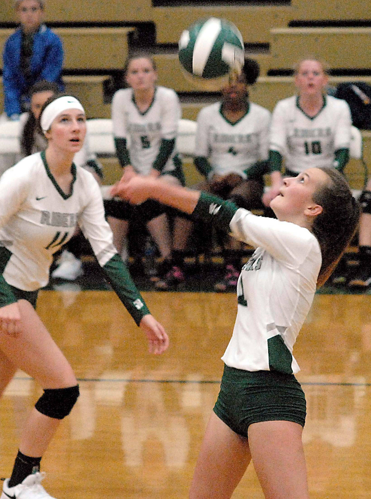 Keith Thorpe/Peninsula Daily News Port Angeles’ Nacia Bohman goes for the ball as teammate Ava Brenkman, left, looks on during the first game of their Tuesday night match against North Mason at Port Angeles High School.