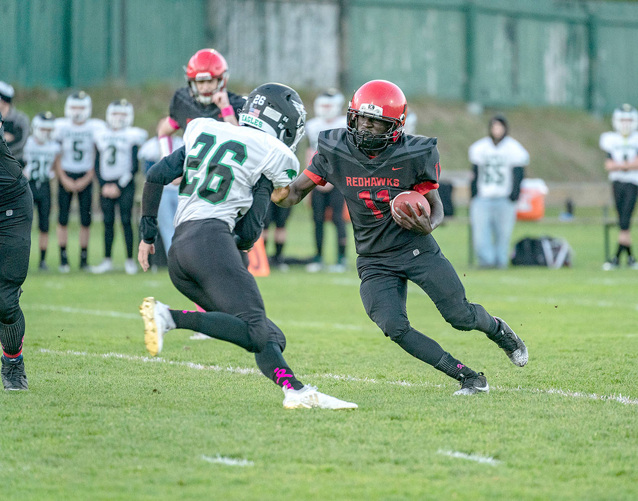 Steve Mullensky/for Peninsula Daily News                                Port Townsend’s Jerome Reaux Jr. gets around Klahowya’s Luke Stahl and picke up a first down in the first quarter of a game played on Friday in Memorial Field in POrt Townsend.