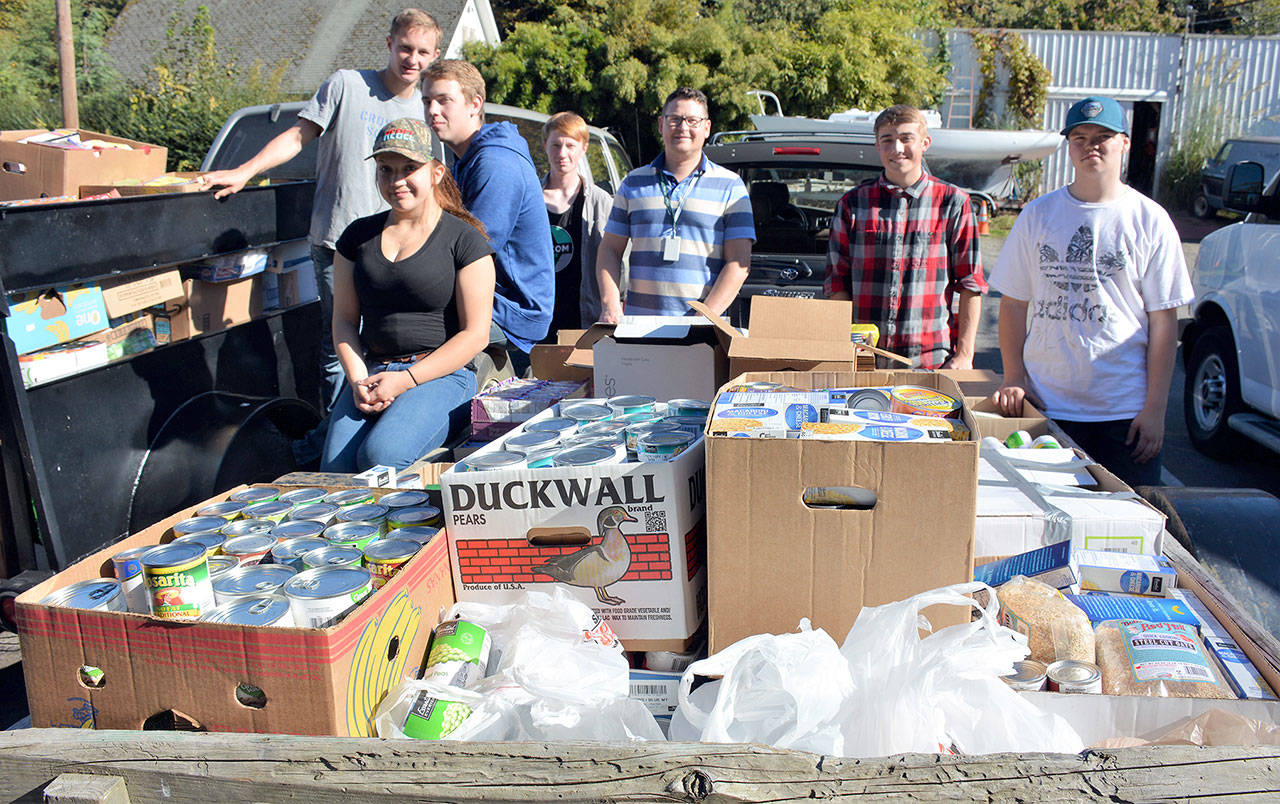 Port Angeles High School students deliver a record amount of food and hygiene items to the Port Angeles Food Bank after their annual school food drive. From left are Sammi Bates, AJ Fischer, Dalton Daugaard, Rylee Lawrence, teacher and freshman class advisor Christian Gentry, Alex Hertzog and Justice Davis. Not shown are PAHS teachers Bernie Brabant, John Gallagher, Dan Helpenstell and Pam Helpenstell, who also helped deliver items to the food bank. (Patsene Dashiell/Port Angeles School District)