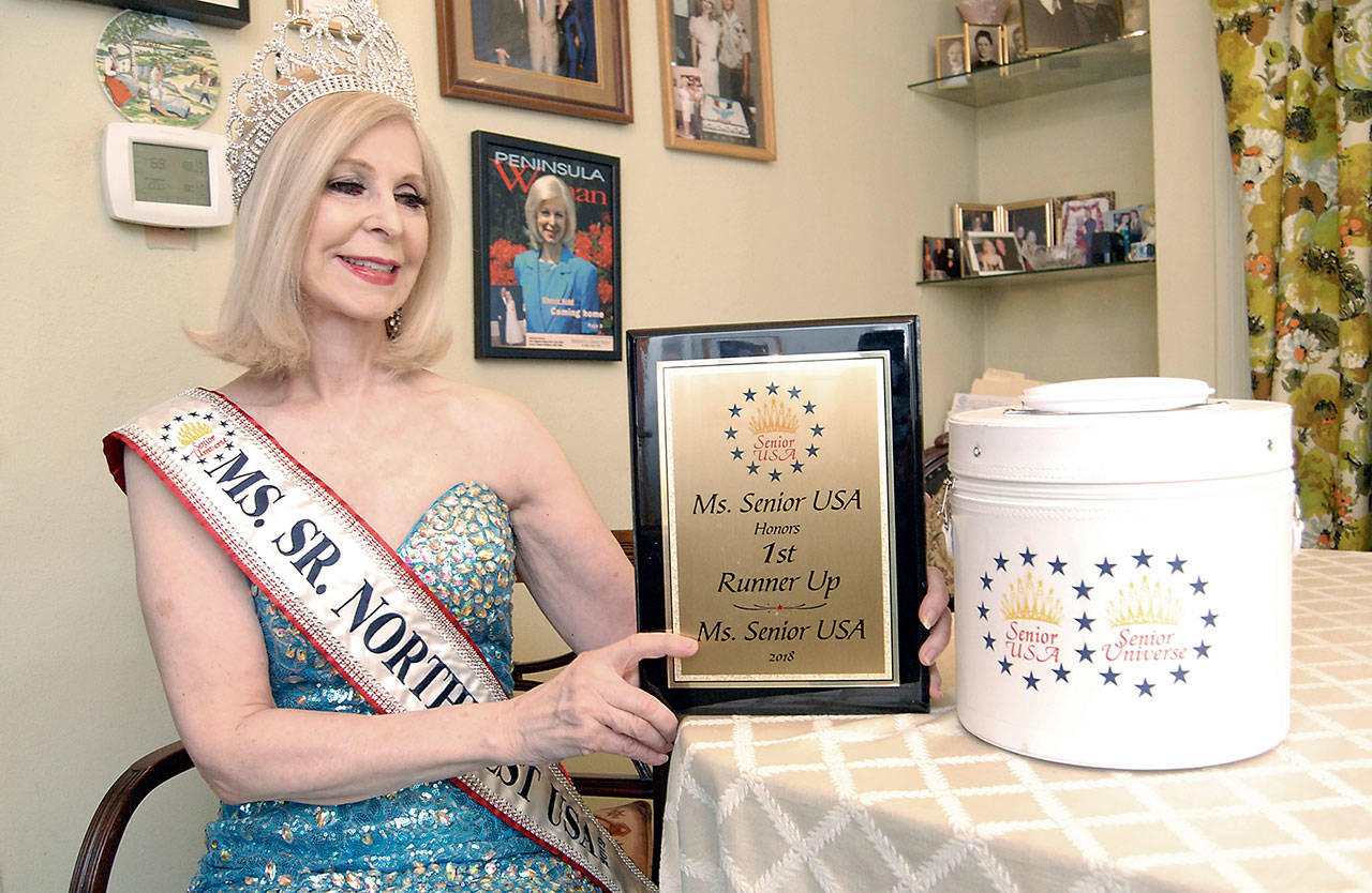 Port Angeles City Council Member Cherie Kidd displays a plaque she received as first runner-up in the 2018 Ms. Senior USA pageant. She will participate in the Ms. Senior Universe pageant this week in Las Vegas. (Keith Thorpe/Peninsula Daily News)