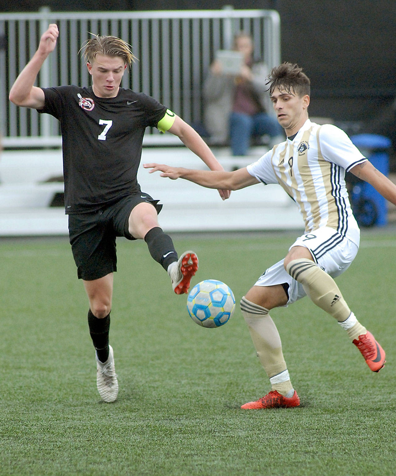 Pierce’s Austin Stafford, left, and Peninsula’s Manuyel Galiano dance around a loose ball during Wednesday’s NWAC first-round playoff game at Wally Sigmar Field in Port Angeles.                                Keith Thorpe/Peninsula Daily News