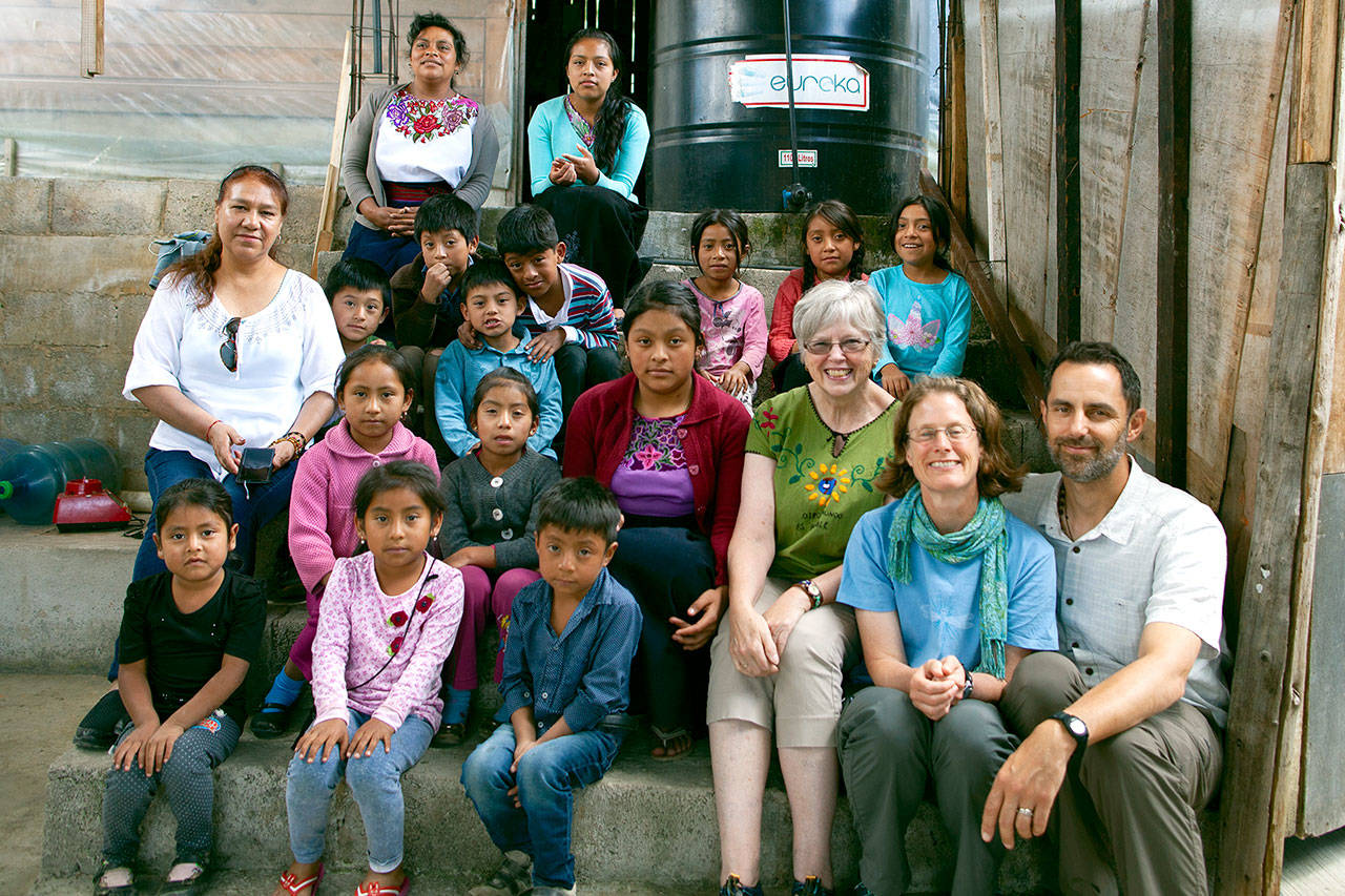 Mujeres de Maiz Opportunity Foundation founder Judith Pasco, in green blouse, beside board members Beth Fetrow and John Boetsch of Port Angeles, traveled to rural Chiapas this summer. A few of the students who take part in Mujeres’ educational projects for children and adults joined them for a picture. (Eric Rust)