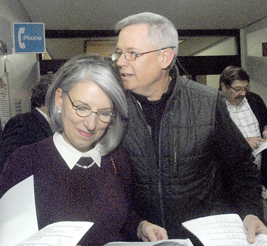 Clallam County Director of Community Development Mary Ellen Winborn, left, looks at election returns with her husband, Clallam County Parks, Fair and Facilities director Joel Winborn. (Keith Thorpe/Peninsula Daily News)