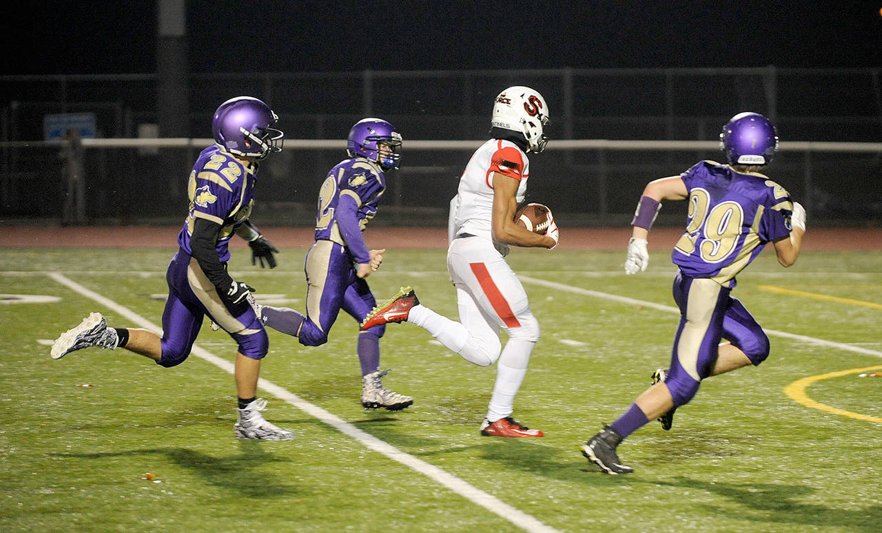 Michael Dashiell/Olympic Peninsula News Group                                Steilacoom sophomore receiver Emeka Egbuka (2) races through the Sequim defense for oneof his three first-half touchdown receptions in the Wolves’ 49-12 loss Friday. From left, Sequim’s Walker Ward Kyler Rollness and Joey Oliver give chase.