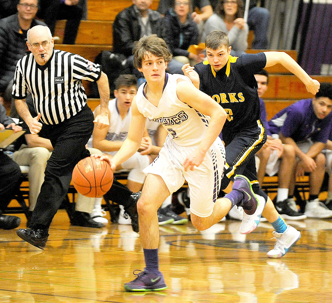 Michael Dashiell/Olympic Peninsula News Group Sequim’s Joey Oliver dribbles away from Forks’ Seth Johnson during the Wolves’ 72-70 win over the Spartans on Monday in Sequim.