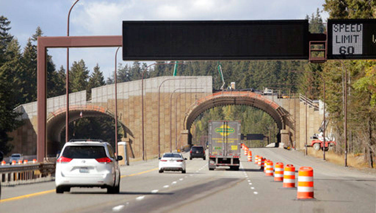 In this photo taken Oct. 4, westbound Interstate 90 traffic passes beneath a wildlife bridge under construction on Snoqualmie Pass. (Elaine Thompson/The Associated Press)