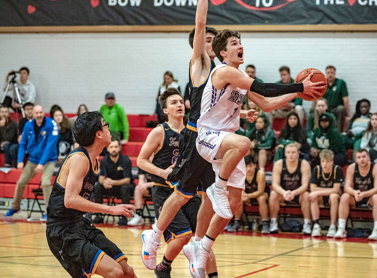 Steve Mullensky/for Peninsula Daily News Sequim’s Nate Despain drives to the basket against 3A Ferndale. The Wolves gutted out a 61-59 win with Despain scoring 14 points and dishing out eight assists. Riley Cowan scored 27 for the Wolves.