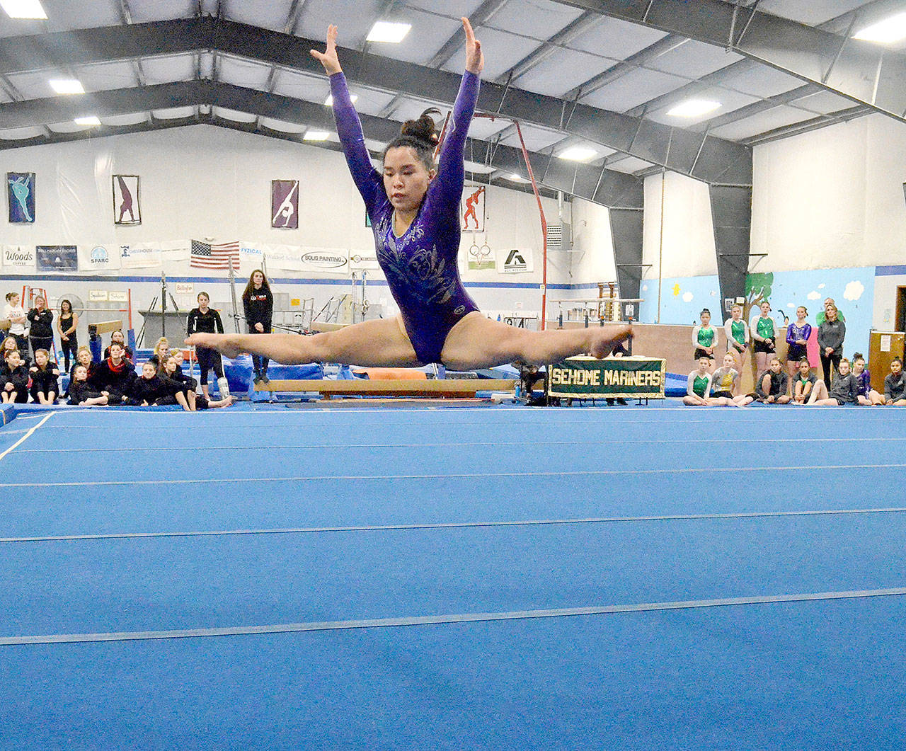 Lesae Pfeffer of Sequim does a jump during her floor routine, earning a score of 8.4, during the Sehome Gymnastics Invitational on Saturday. Pfeffer competes for a combined Port Angeles/Sequim/Crescent team.